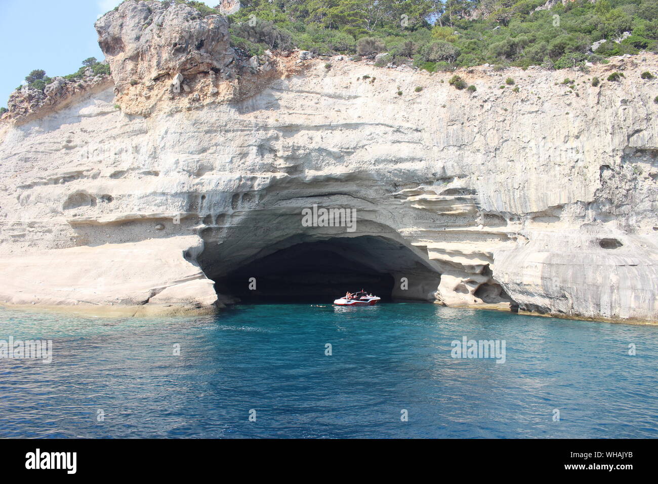 Boat Under Cave On Sea Stock Photo