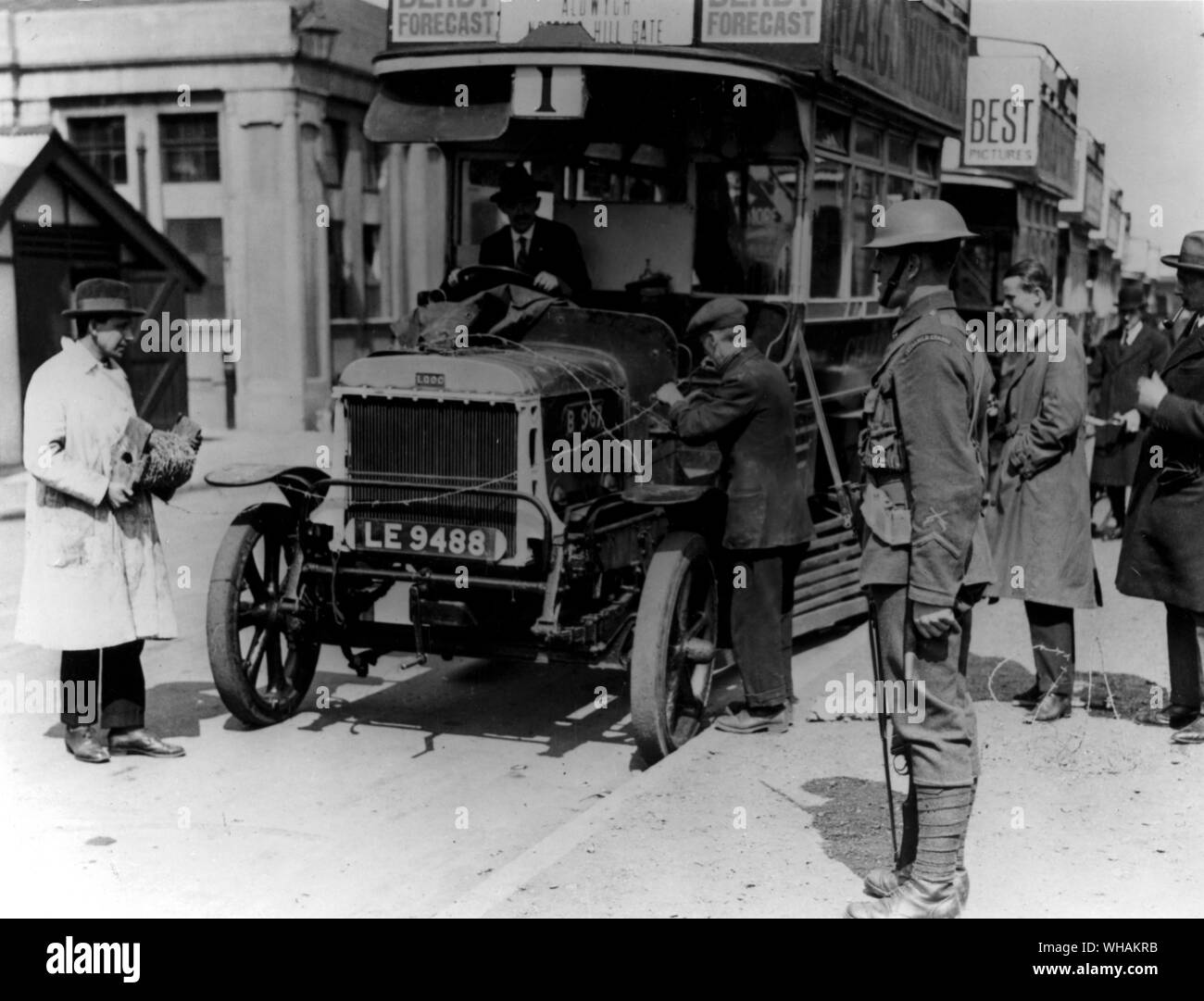 The wiring of the bonnets of the buses to stop strikers getting on the engines. note the soldier on guard Stock Photo