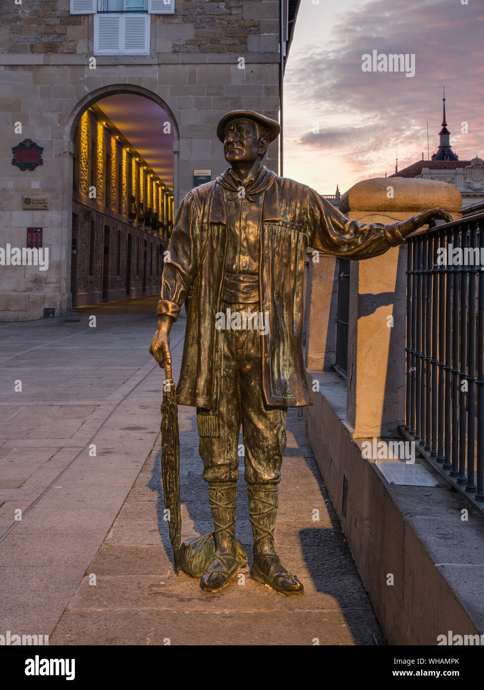 Statue of Celedon, traditional character of the city festival, in front of the colorful lighted Los Arquillos passageway Stock Photo