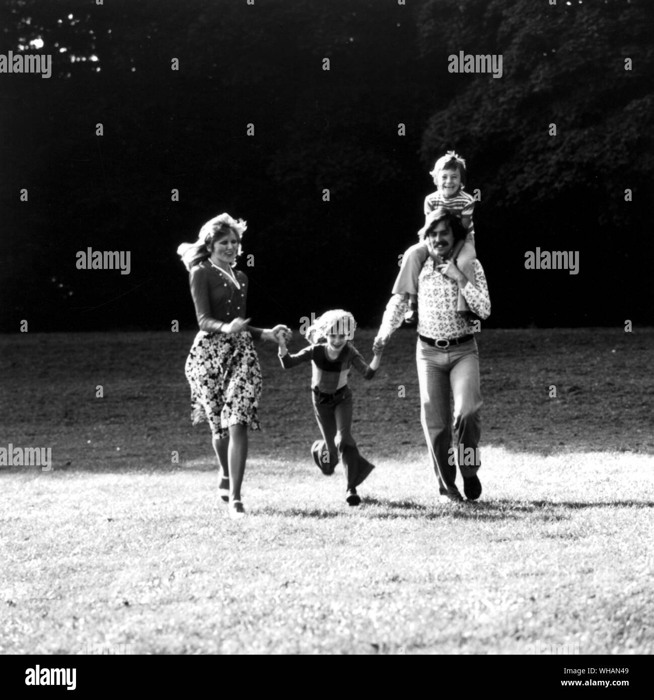 You and the family. Mother, father and two children. running, together, relaxing, fun, happy, healthy Stock Photo