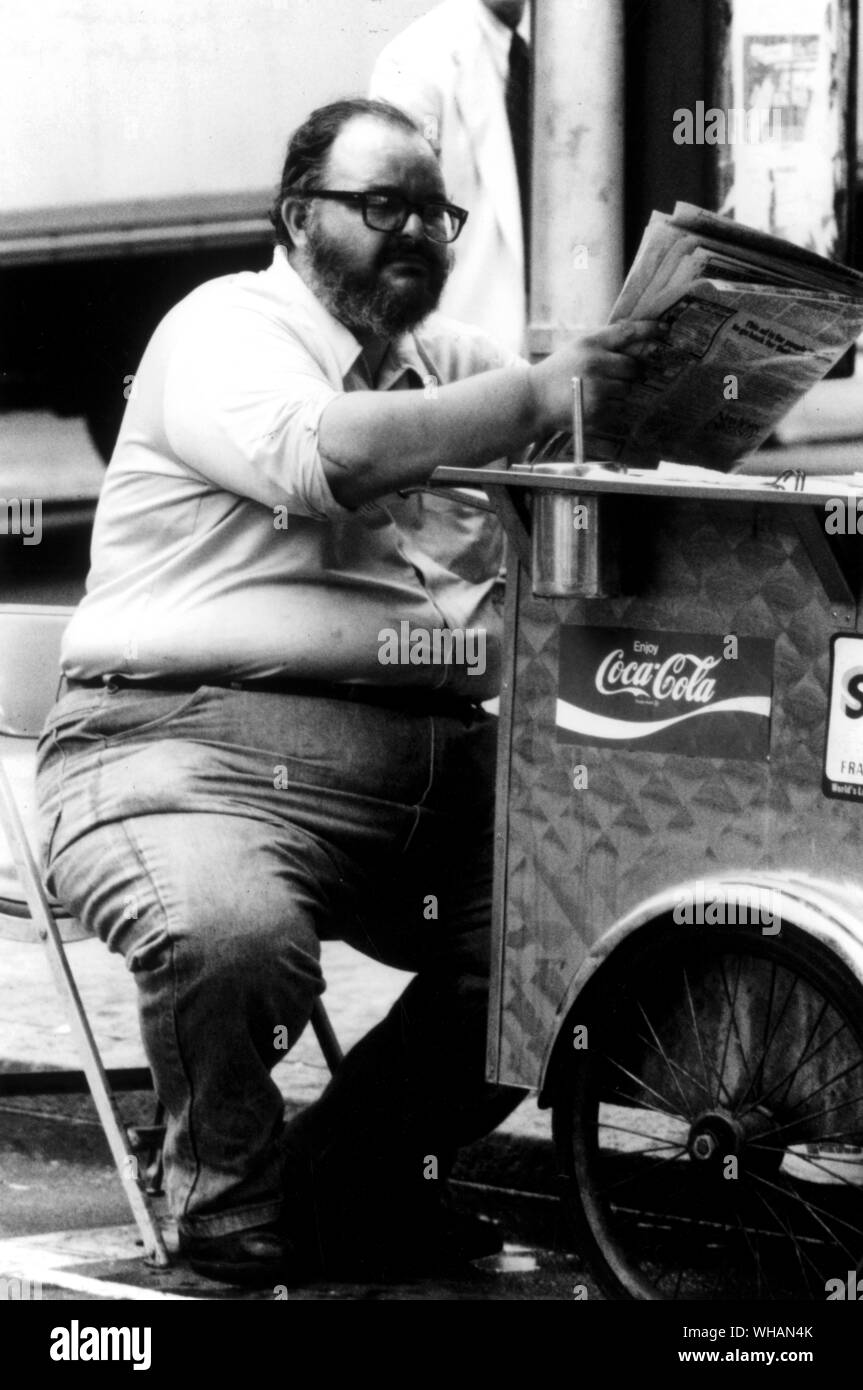Obese man reading the paper . Stock Photo