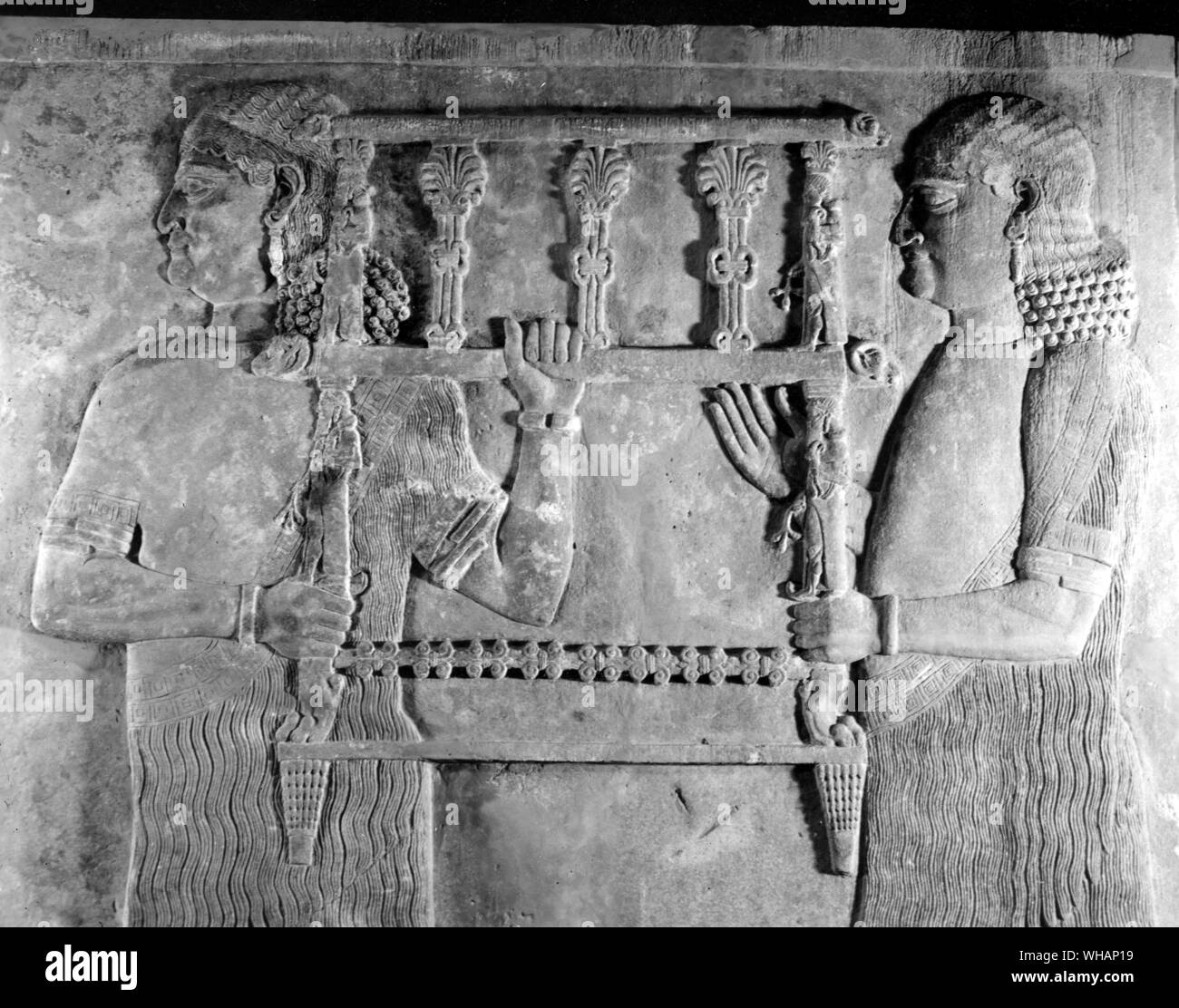 Stone bas relief showing Tiglath Pileser III ( 744-727BC) seated on a throne. Neo Assyrian period Stock Photo