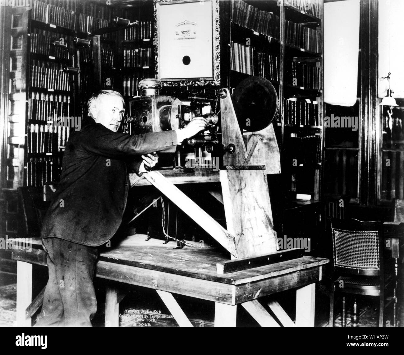 Edison with motion picture machine (not his own make) in West Orange Library 1897 . . . . Edison, Thomas Alva (the Wizard of Menlo Park) US inventor. opened research laboratory in Menlo Park, New Jersey 1876 (moved to West Orange, New Jersey 1887). invented phonograph (1st demonstrated 1877). invented incandescent electric light 1879. invented kinetograph camera and kinetoscope motion-picture viewer (patented 1891)  1847-1931 . . . . . Stock Photo