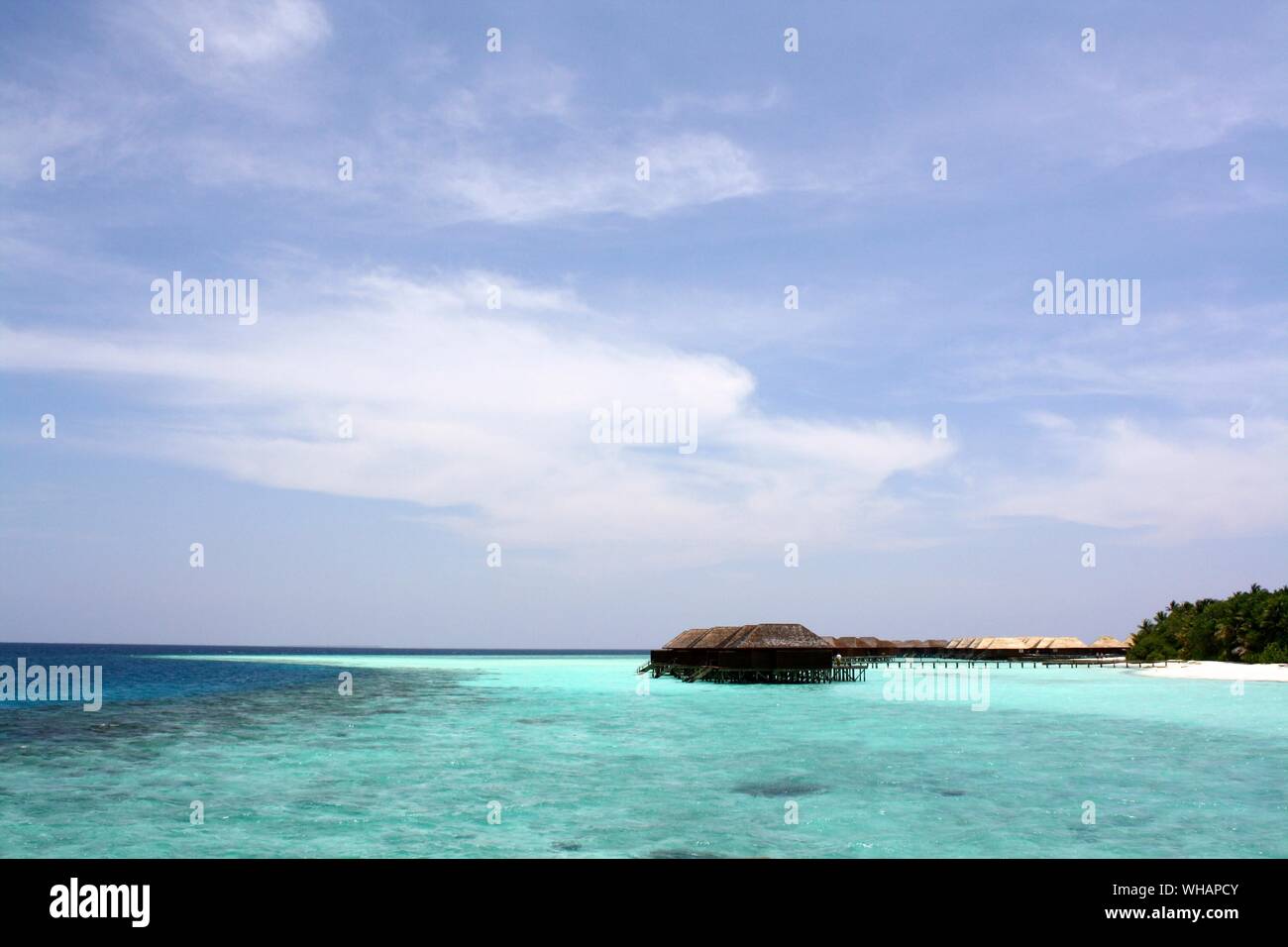 A Thatched Hut On The Edge Of A Tropical Beach Stock Photo