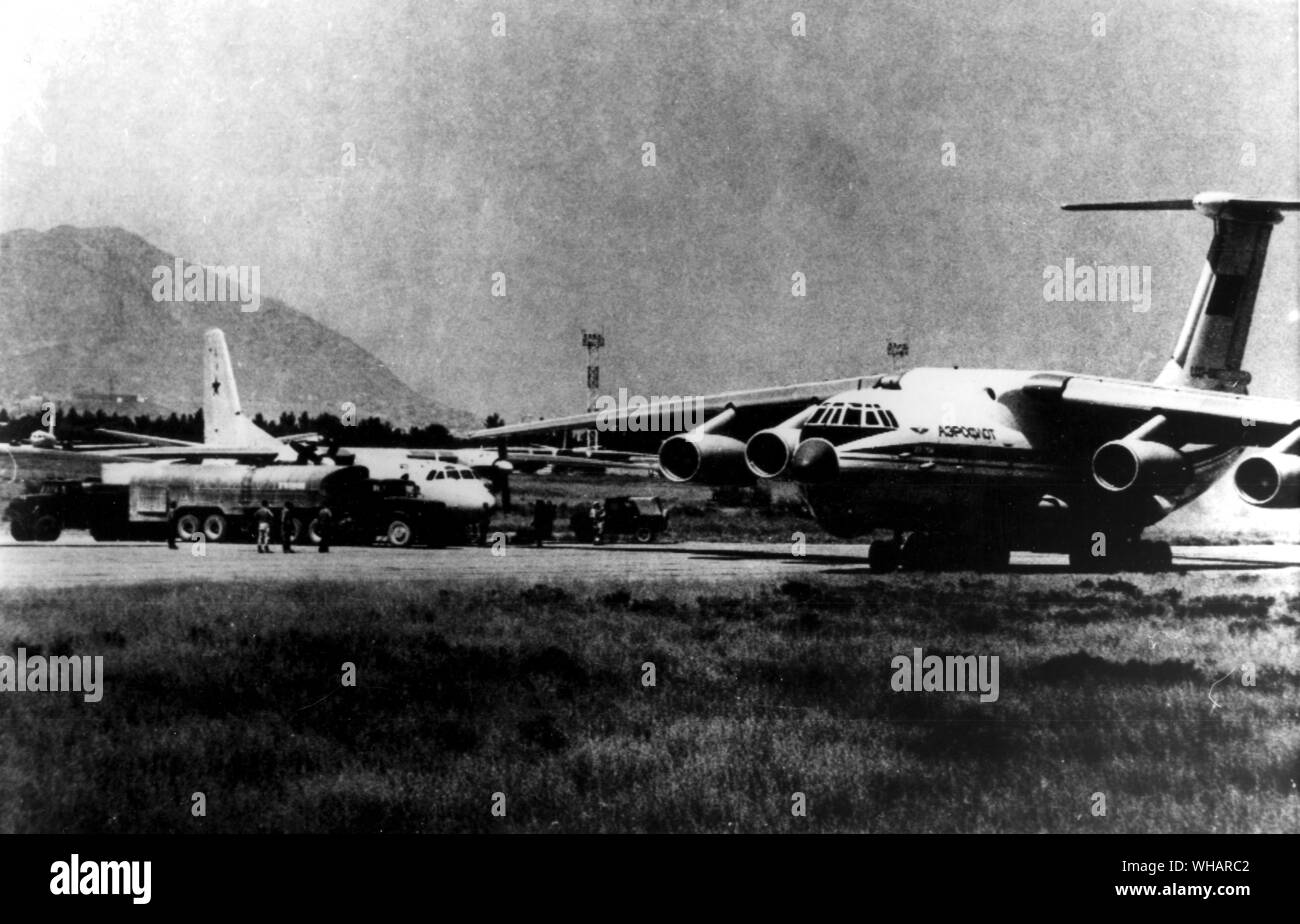 Russian crews are servicing a troop transport airplane at Kabul airport near a Soviet Aeroflot Airline plane which is also used for troops. 1980 Stock Photo