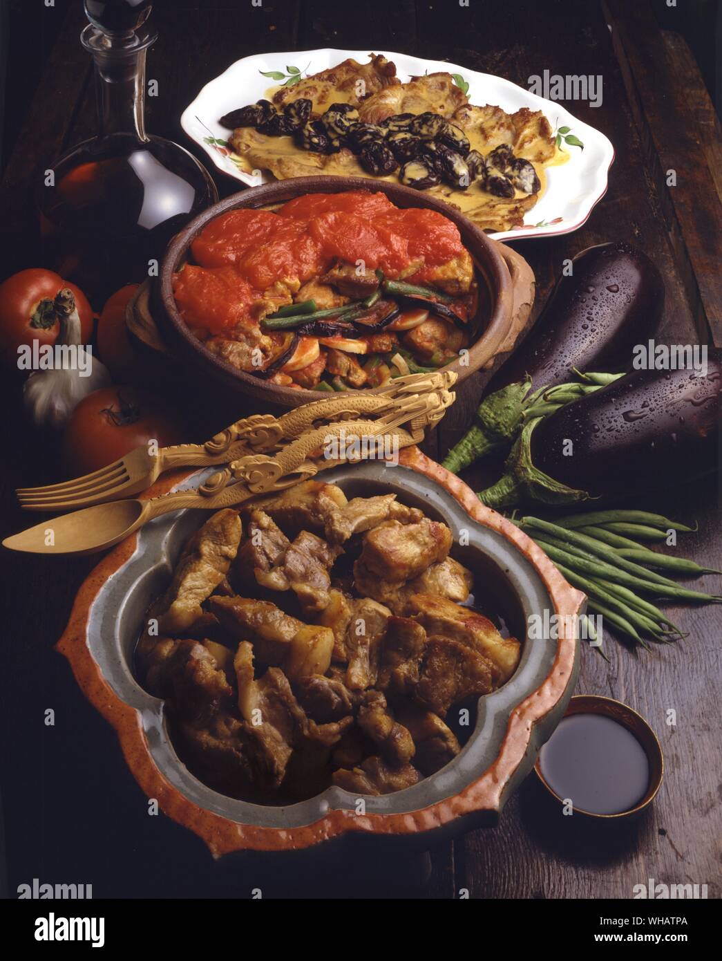 International Cooking . Top to Bottom, Pork Fillets With Prunes.. Noisettes De Porc Aux Pruneaux, France.. . Pork And Vegetable Stew.. Djuvec, Yugoslavia.. . Pork In A Sour Sauce.. Adobo, Philippines. Stock Photo