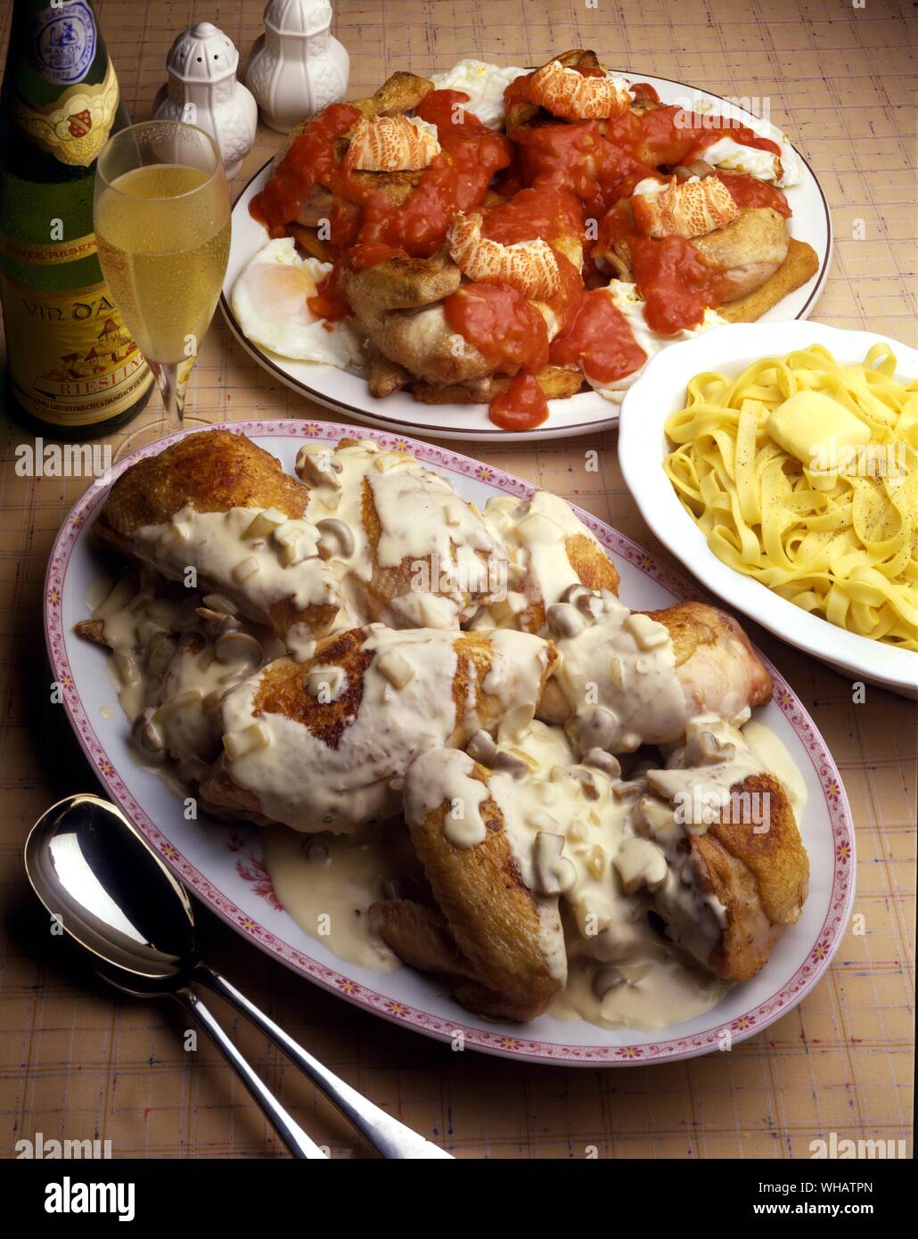 International Cooking . Top Chicken Marengo.. France Or Italy.. Bottom, Alsace-Style coq Au Vin.. Coq Saute Au Riesling, France. Stock Photo