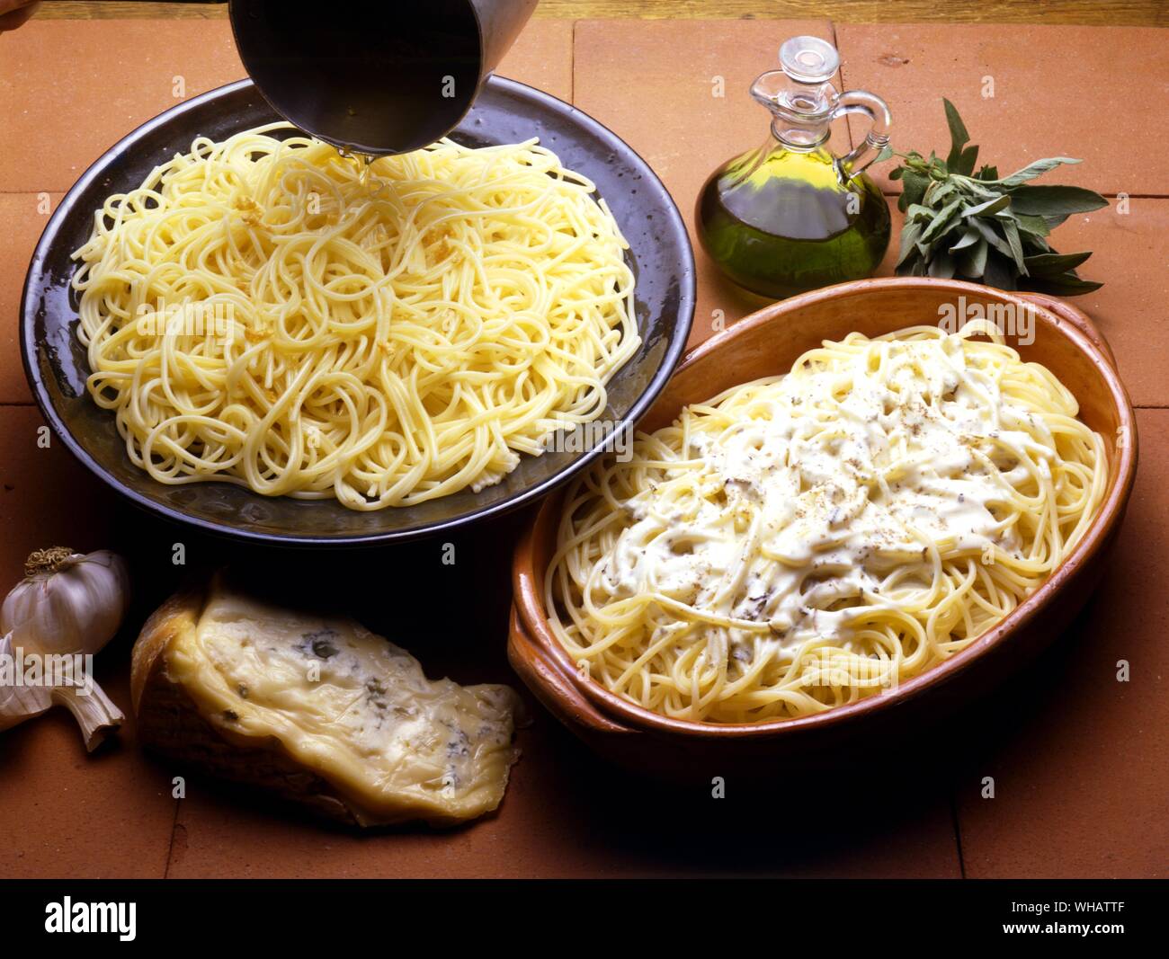 Italian Cooking . . Left.. Spaghetti All'Aglio Ed Olio.. Spaghetti With Garlic and Oil.. . Right.. Spaghetti Al Gorgonzola.. Spaghetti With Gorgonzola.. Stock Photo