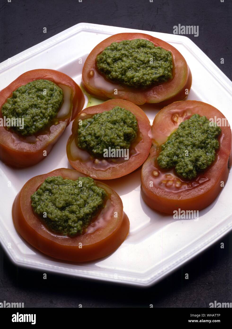Italian Cooking By Robin Howe. . Pomodori Alla Salsa Verde.. Tomatoes With A Green Sauce. Stock Photo