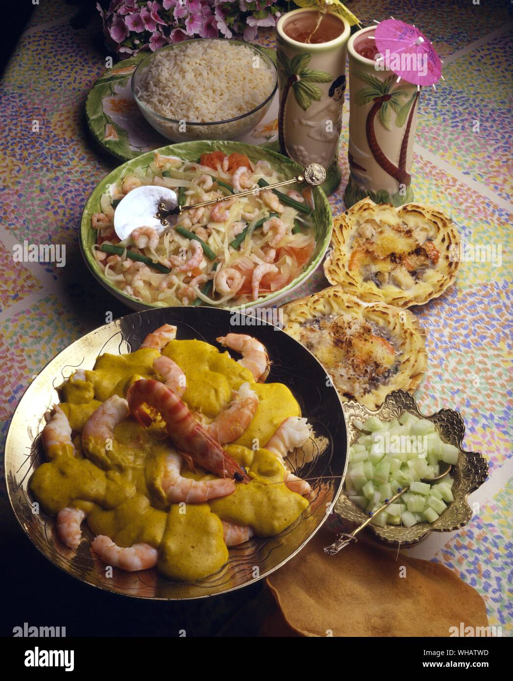 International Cooking . Top Left, Prawn stew.. Gulai Guisado, South Pacific.. Top Right, Scallops Au Grantin.. Coquilles St Jacques, France.. Bottom, Prawn Curry.. Fhinga Ki Kari, India. Stock Photo