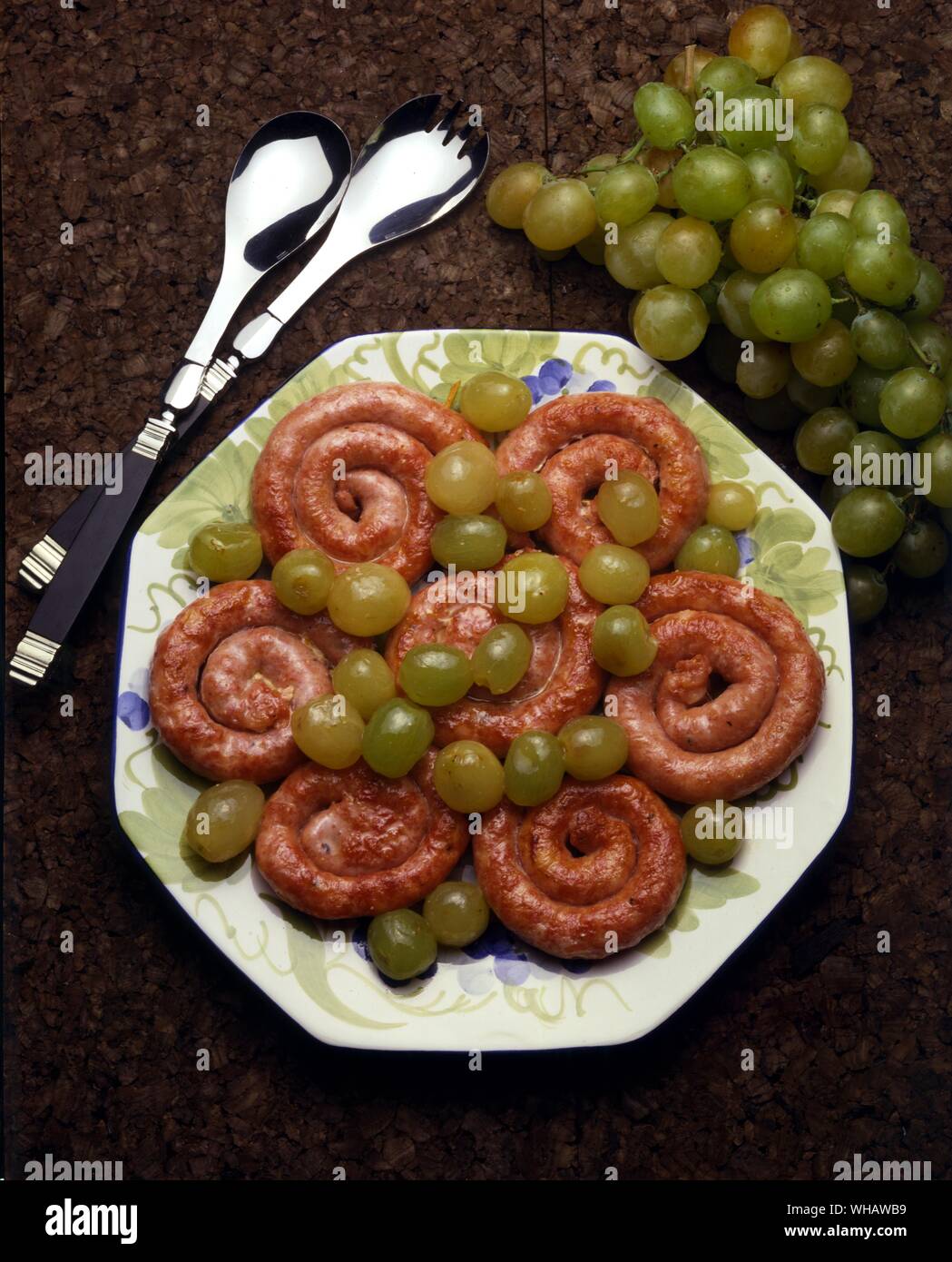 Italian Cooking By Robin Howe. . Salsicce Con L'uva Fresco.. Pork Sausages With White Wine. Stock Photo