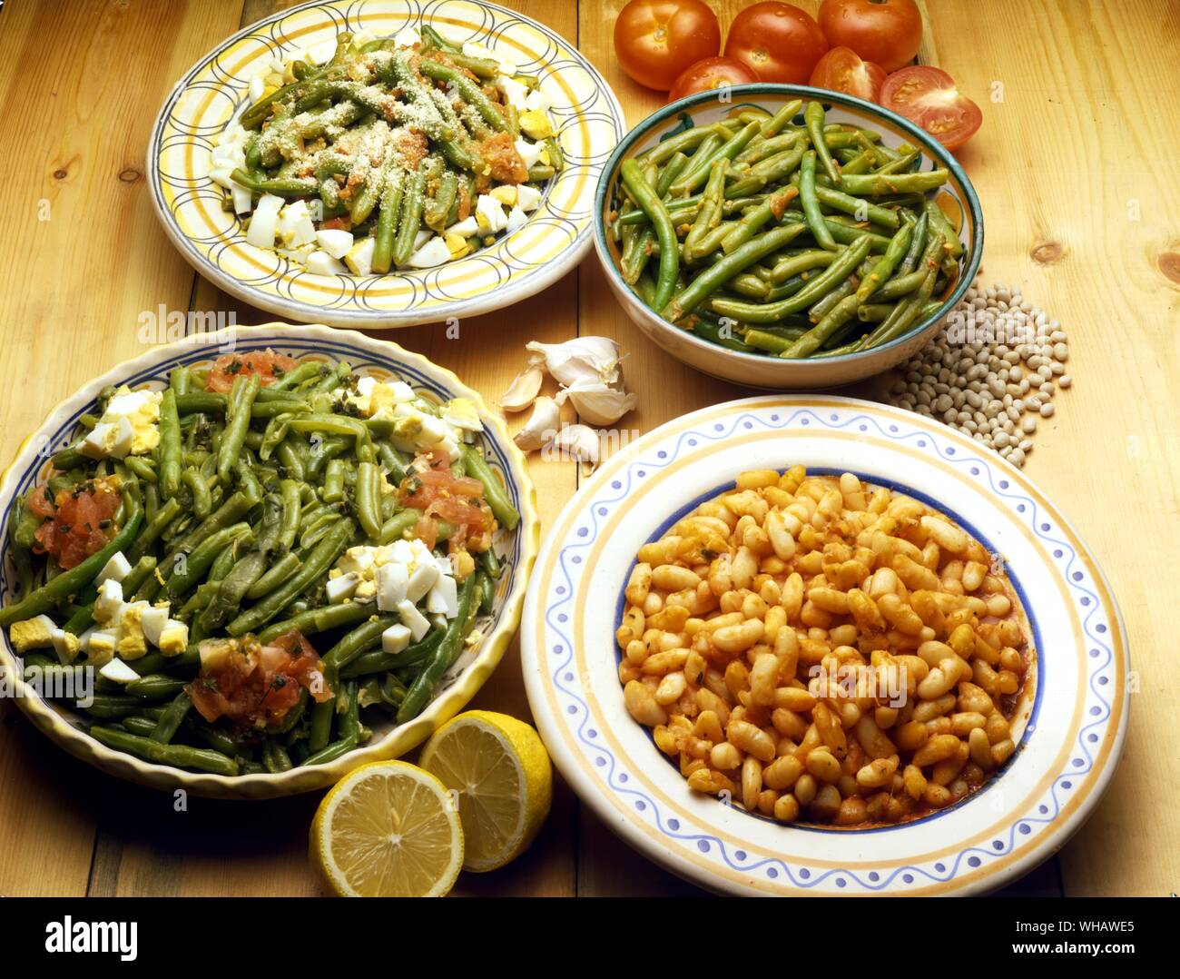 Italian Cooking . . Top, Left.. Fagiolini In Padella or Alla Napoletana.. French Beans Cooked With Tomatoes.. . Right.. fagiolini Rifatti.. Twice-Cooked Green Beans. . Bottom, left.. Fagiolini Al Sugo Di Limone.. French Beans With Lemon.. . Right.. Fagioli All'Uccelletto.. Dried Beans Cooked In Sage. Stock Photo