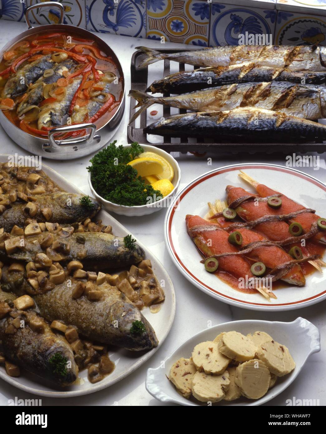 French Recipes . . Clockwise From Top Left.. Sardines A L'Escabeche.. Marinated Sardines.. . Marquereau A La Diable.. Devilled Mackerel.. . Rougets A La Nicoise.. Red Mullet.. . Truites A La Grenobloise.. Grenoble Trout. Stock Photo