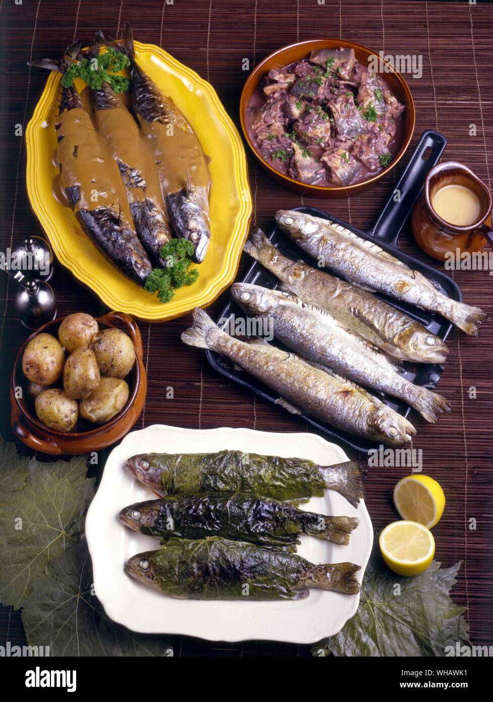Harengs en matelote. Herrings in red wine sauce. . Maqueraux a l'oleronnaise. Grilled mackerel with mustard and spices. . Truites grillees sauce piquante. Grilled trout with sauce piquante . . Truites a la Bresle. Trout cooked in vine leaves Stock Photo