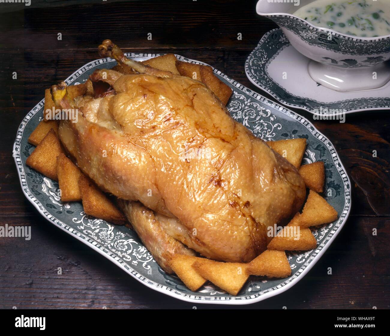 Roast Duckling with Green Peas Stock Photo
