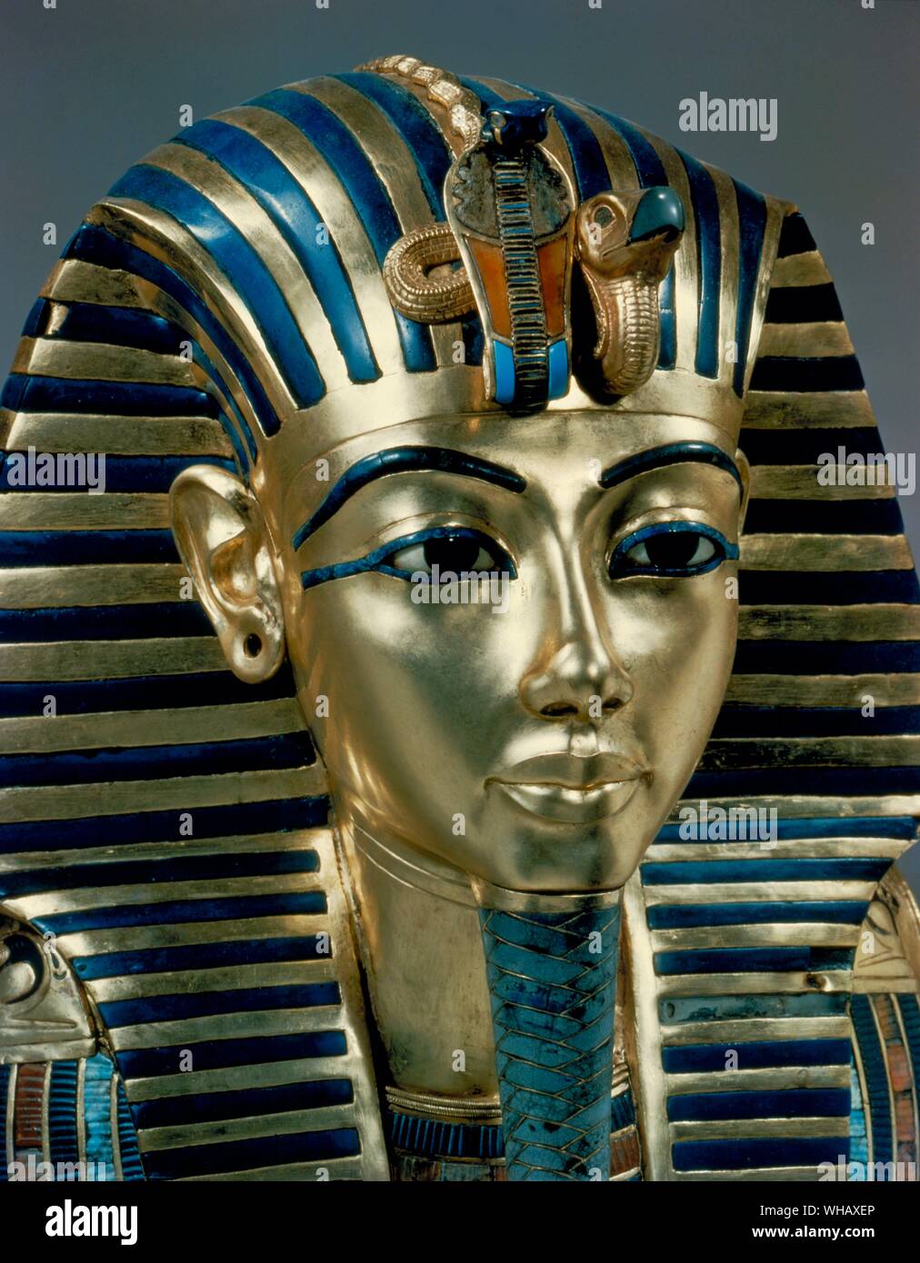 Tutankhamen - Tut Pl. 26 (XXVI) Gold Mask (found by Howard Carter). Tutankhamen's funeral mask in solid gold, inlaid with semi-precious stones and glass paste. Tukankhamen, by Christiane Desroches Noblecourt, The mask of Tutankhamen's mummy is now a popular icon for Ancient Egypt - the close-up of Tutankhamun's facial features as represented by 18th Dynasty artisans in the young king's death mask. The Egyptologist Howard Carter (employed by Lord Carnarvon) discovered Tutankhamun's tomb (since designated KV62) in The Valley of The Kings on November 4, 1922 near the entrance to the tomb of Stock Photo