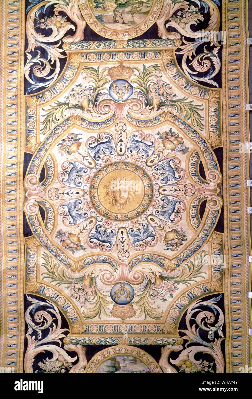 Detail from a Savonnerie carpet for the Grande Galerie of the Louvre, Paris, France. The Sun King by Nancy Mitford, page 113.. In 1608 Henry IV initiated the French production of Turkish style carpets under the direction of Pierre Dupont. This production was soon moved to the Savonnerie factory in Chaillot just west of Paris. The earliest, well-known group produced by the Savonnerie, then under the direction of Simon Lourdet, are the so-called Louis XIII carpets. This is a misnomer, however, as they were produced in the early years of Louis XIV's reign (circa 1743-1761). The designs are based Stock Photo