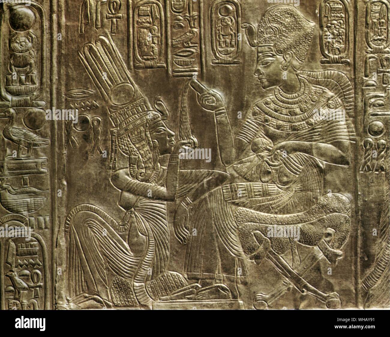 Details of the exterior of the gilt shrine. The king pours a perfumed liquid into the queen's hand. Tukankhamen, by Christiane Desroches Noblecourt, page 41.. The external walls and the doors of the shrine are subdivided into panels framed by hieroglyphic inscriptions with scenes showing Tutankhamun and his wife in various aspects of married life, a theme that recalls the scenes of the Amarna Period. The entire decorative scheme of the shrine has strong symbolic connotations associated with the religious and political spheres. The intimate ties between the pharaoh and his bride represent the Stock Photo