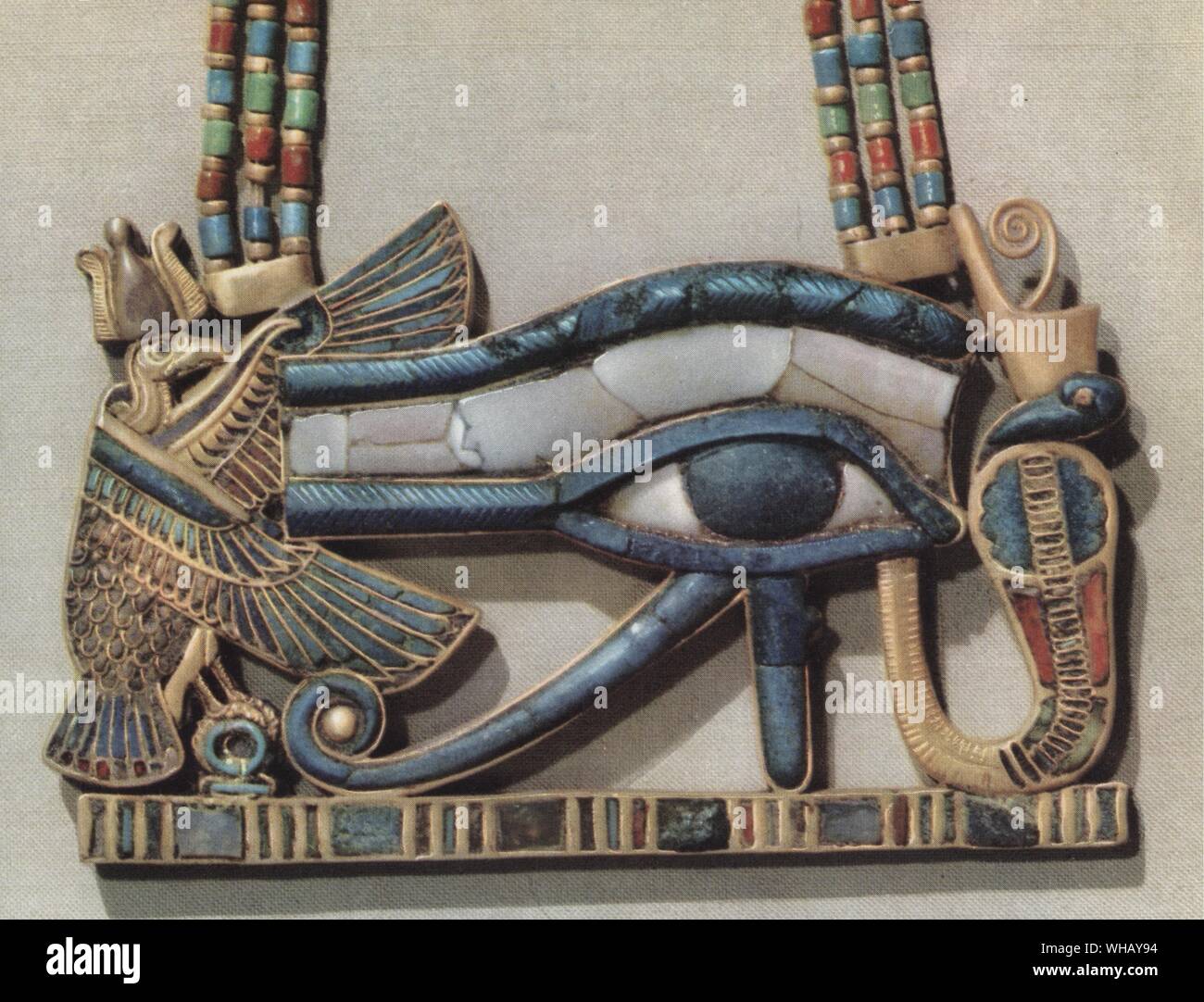 The king's pectoral decorated with the sacred eye flanked by the serpent goddess of the North and the vulture goddess of the South. Gold cloisonné with glass paste. Tukankhamen, by Christiane Desroches Noblecourt, page 187.. The vulture was the symbol of Upper Egypt. Pharaohs wore the uraeus (cobra) and the head of a vulture on their foreheads as symbols of royal protection. The goddess Nekhbet was also portrayed as a vulture. Stock Photo