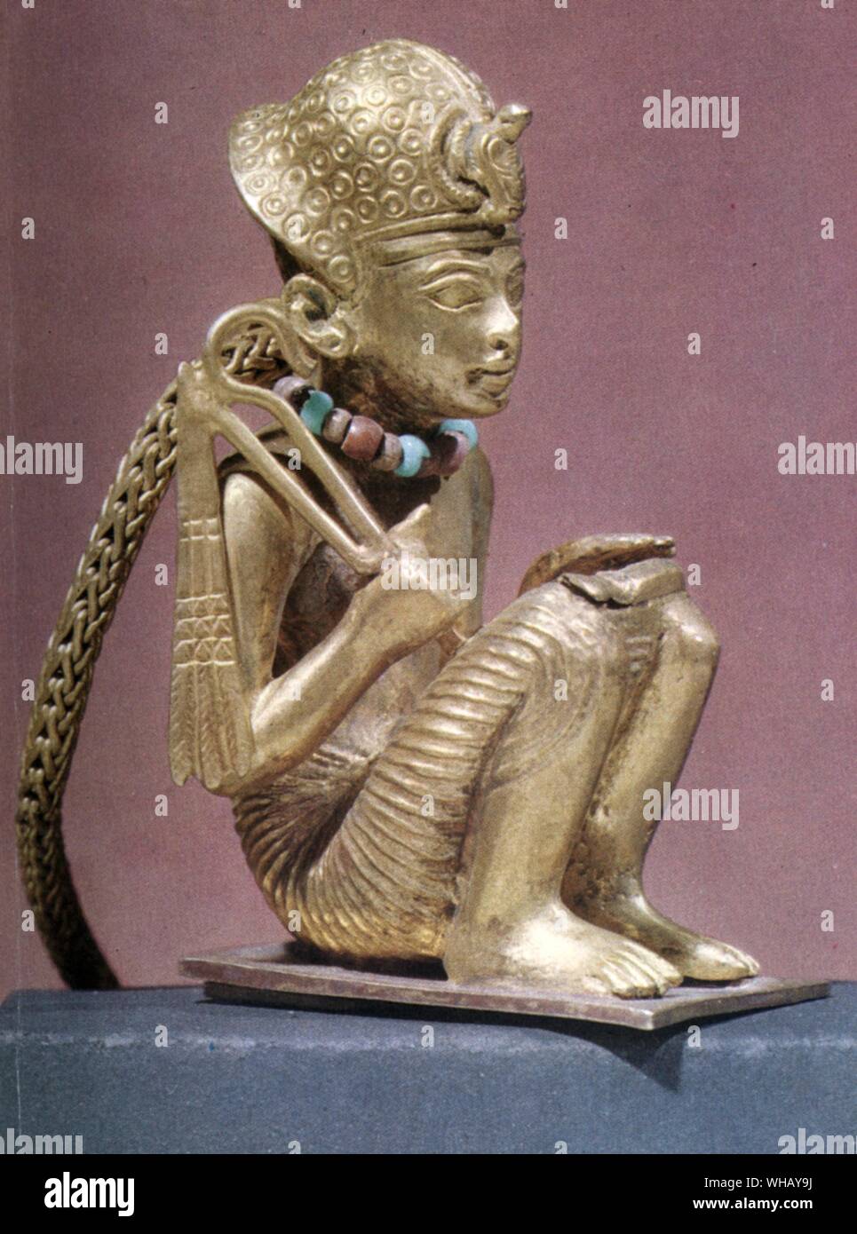 Tiny statuette of Amenophis III found in a small mummiform coffin. Solid Gold. Tukankhamen, by Christiane Desroches Noblecourt, page 23. Stock Photo