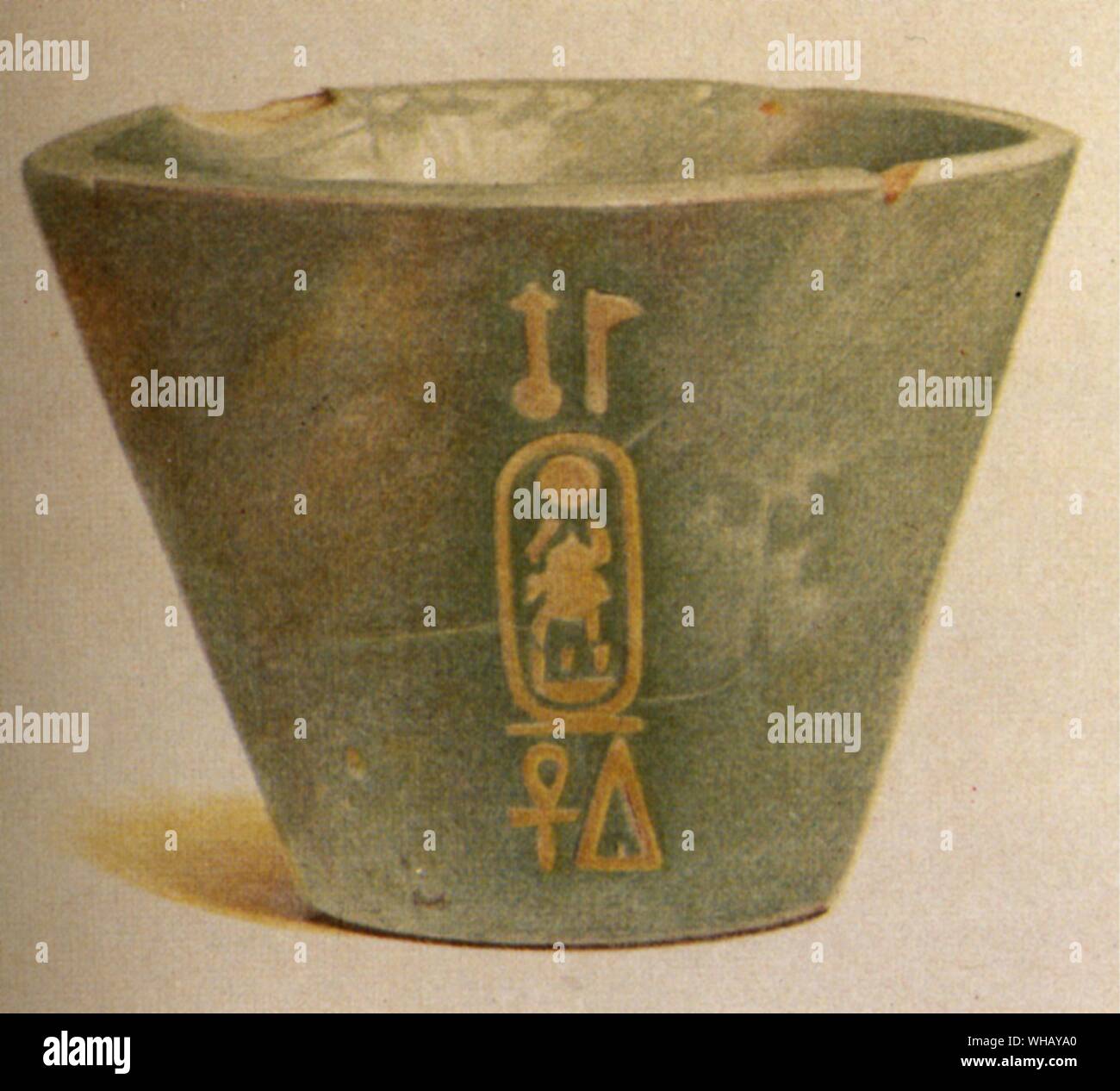 The blue green faience cup of Tutankhamen found by Ayrton under a boulder in the gully containing Amenhotep II's tomb. Tutankhamun (alternate transcription Tutankhamen), named Tutankhaten early in his life, was Pharaoh of the Eighteenth dynasty of Egypt (ruled 1334 BC/1333 BC-1323 BC, lived ca. 1341 BC-1323 BC), during the period known as the New Kingdom. Aakheperure Amenhotep II (d. 1400 BC) was the seventh Pharaoh of the 18th dynasty of Egypt. He ruled from 1427 BC to 1400 BC.. Valley of the Kings by John Romer, page 217. Stock Photo