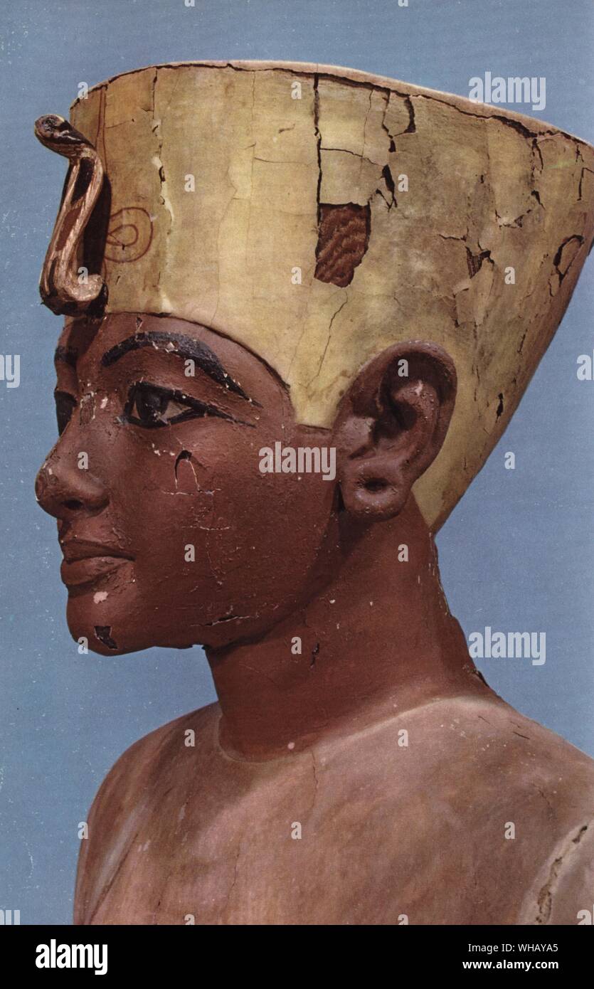 Head of a dummy of the young Tutankhamen wearing a compromise between the crown of the kings of Lower Egypt and the headdress of Nefertiti. Stuccoed and painted wood. Tukankhamen, by Christiane Desroches Noblecourt, page 194.. Kings are often represented wearing the nemes headcloth, a piece of cloth pulled tight across the forehead and tied at the back, with two flaps hanging on the sides. Cobra (uraeus) and vulture heads were worn on the forehead.. The vulture was the symbol of Upper Egypt. Pharaohs wore the uraeus (cobra) and the head of a vulture on their foreheads as symbols of royal Stock Photo