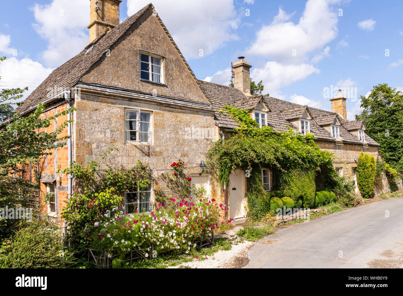 Summer flowers on Cotswold stone cottages in the village of Wood Stanway, Gloucestershire UK Stock Photo