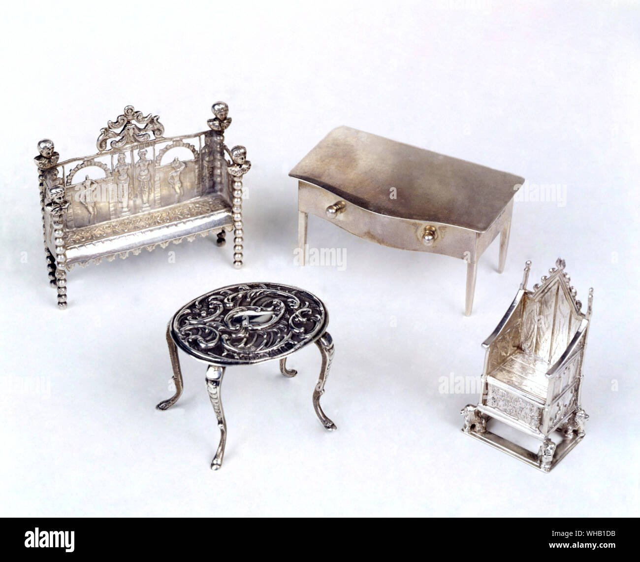 Group of miniature silver, including settee, Dutch, with English import mark for 1903. table, 1902. and a replica of the Coronation chair, 1901.. Claire Barrett Street Antique Market.. Stock Photo