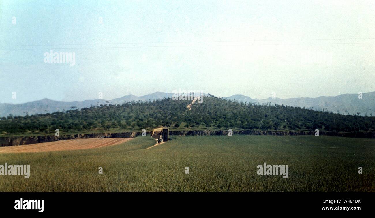 The tomb mound of the First Emperor of China with Mount Li in the background . Stock Photo