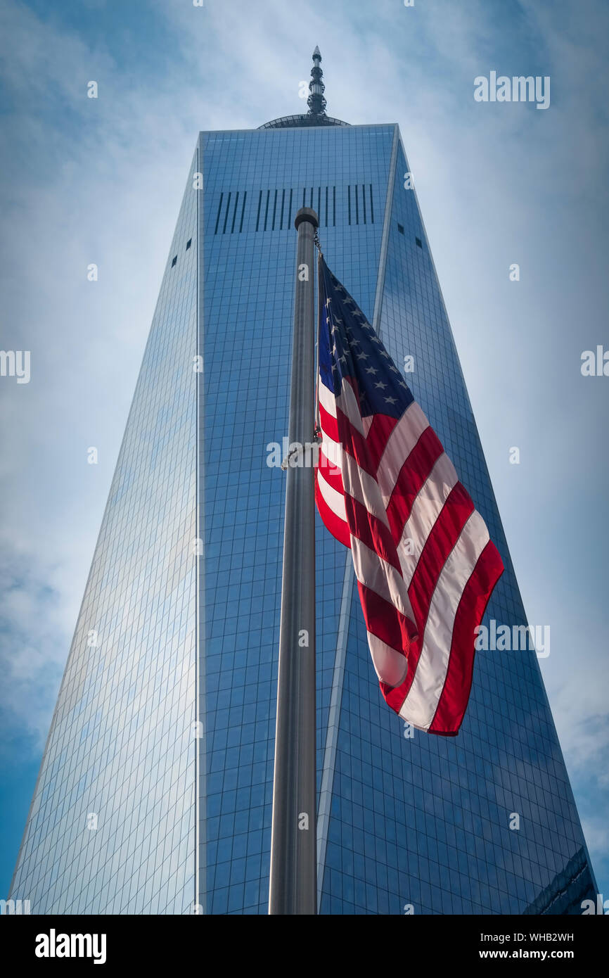 The One World Trade Center and Stars and Stripes Flag viewed from Ground Zero, New York, USA Stock Photo
