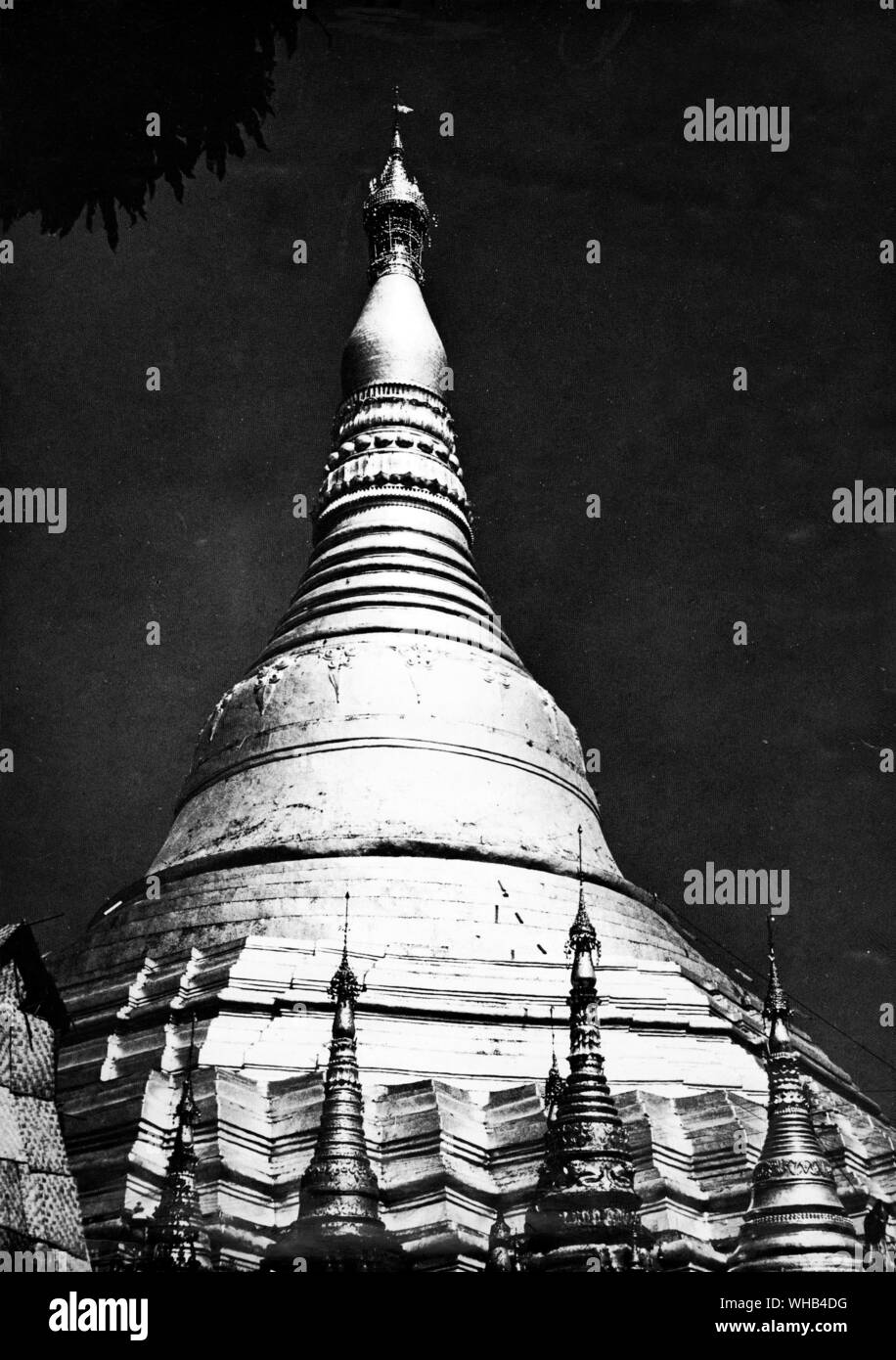 The Shawa Dragon Pagoda in Rangoon -. The majestic Shwedagon (Golden Dagon) Pagoda, Rangoon, Myanmar, dominates the Rangoon skyline from every vantage point. For Burmese Buddhists this is the most sacred of all sites in Myanmar, one which all Burmese aspire to visit at least once in their lifetimes. Legend has it that the Shwedagon was built to house 8 hairs of the Buddha. these rest in a chamber below a golden slab under the large golden stupa (dome). The golden stupa rises 98m and is solid in construction. It is believed to have been built by the Mon people between the 6th and 10th Stock Photo