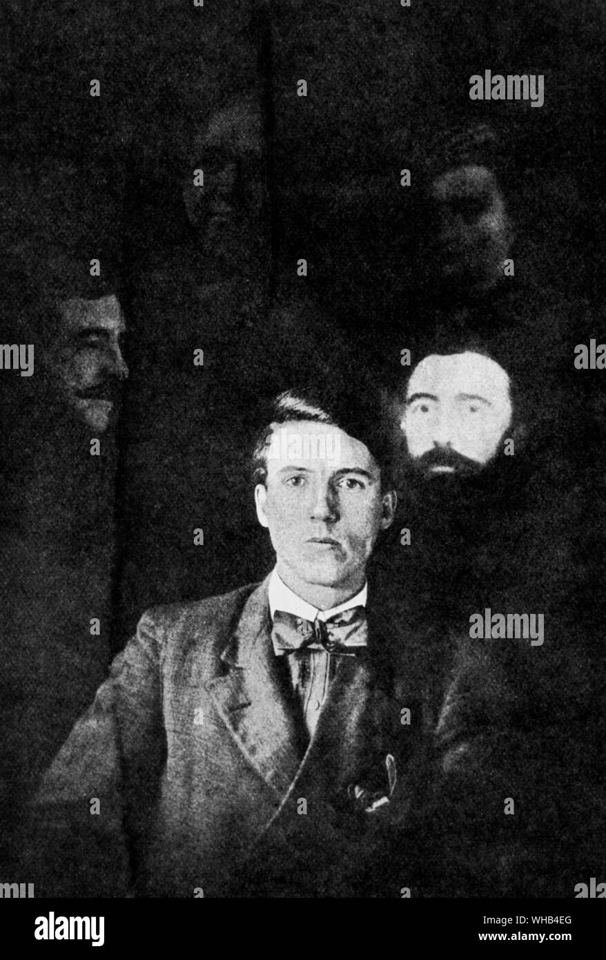 From:  Personal Experiences in Spiritualism (Laurie). SPIRIT PHOTOGRAPH (Taken by A. Norman.  Showing the faces of various so-called guides). Stock Photo