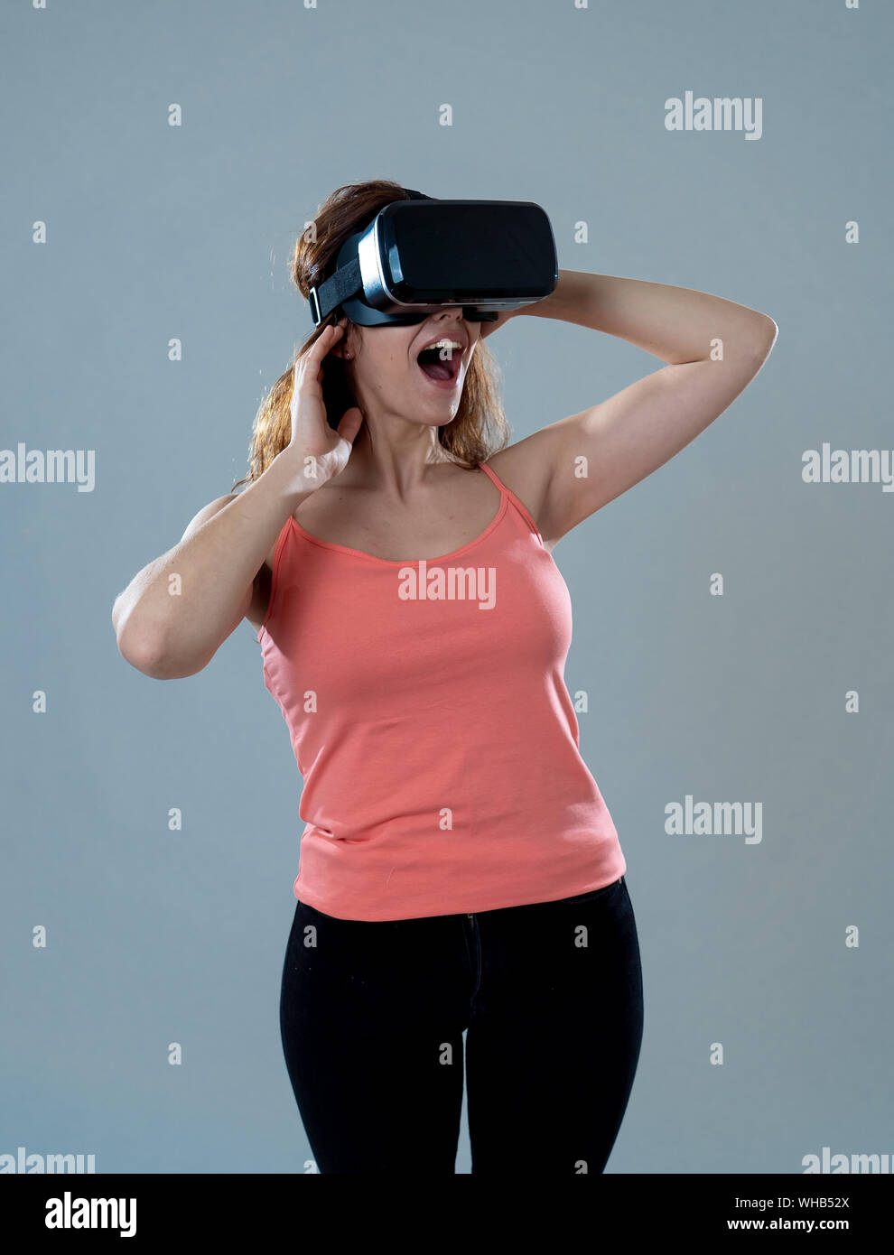 Amazed woman getting experience using VR headset glasses, feeling ...