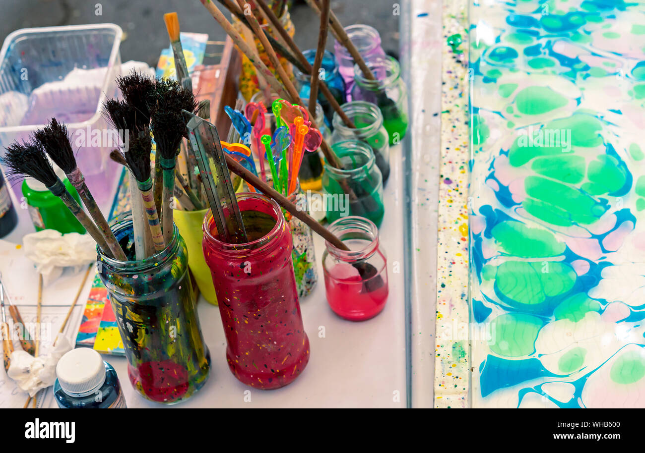 Tools for drawing on water in the technique of ebru. Putting paints on water with the subsequent transfer of the resulting pattern on paper. Stock Photo
