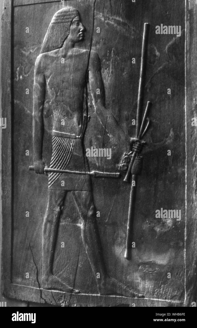 Wooden panel of the royal scribe Hesi-Re. III Dynasty - Cairo Museum. He holds his scribal palette and pens in his left hand - Large Hesire from Saqqara - A three dimensional relief portrait of Hesire, carved into the wooden door of his tomb (c.2700 BC) also gives valuable insights into how the mind of an AE designer/artist worked - the design/stylistic conventions/rules they were using. Everything had to be represented from it s most characteristic angle. The head was most easily seen in profile so they drew it sideways. But if we think of the human eye we think of it as seen from the front. Stock Photo