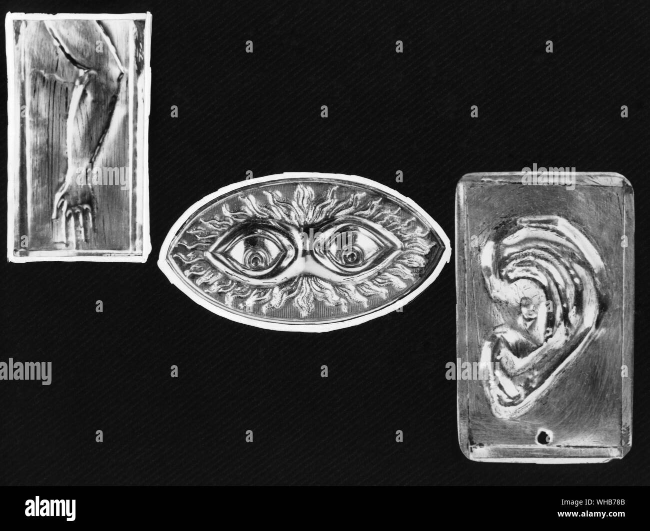 Models of fish will ensure a good catch and disease will be healed by means of votive offerings depicting the afflicted part of the body in a healthy state . Silver votive offerings for cures 19th century Stock Photo