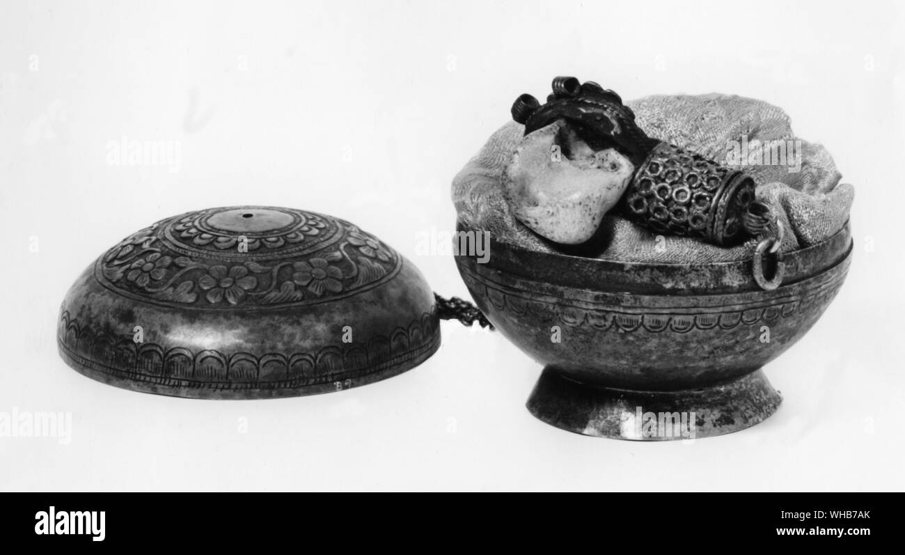 Contagious Magic. Contact with a saint's relic part of his body or clothing will cure or aid the devotee as the saint himself would have done. Silver box containing bone relic of a Buddhist saint from Tibet Stock Photo