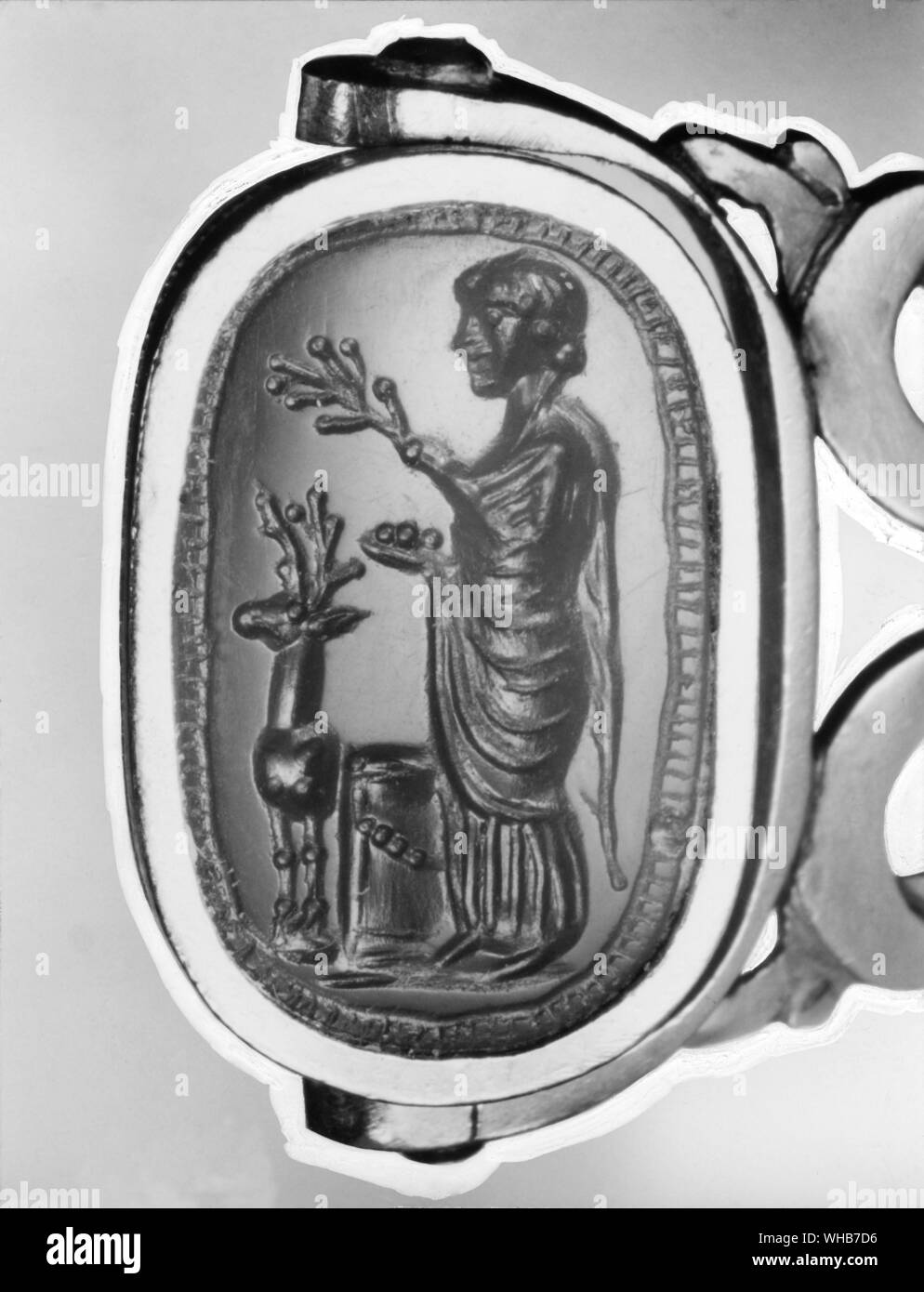 Diana goddess of nature  . Roman gem stone showing Diana holding a branch and a bowl of fruit at her side is the sacred stag Stock Photo