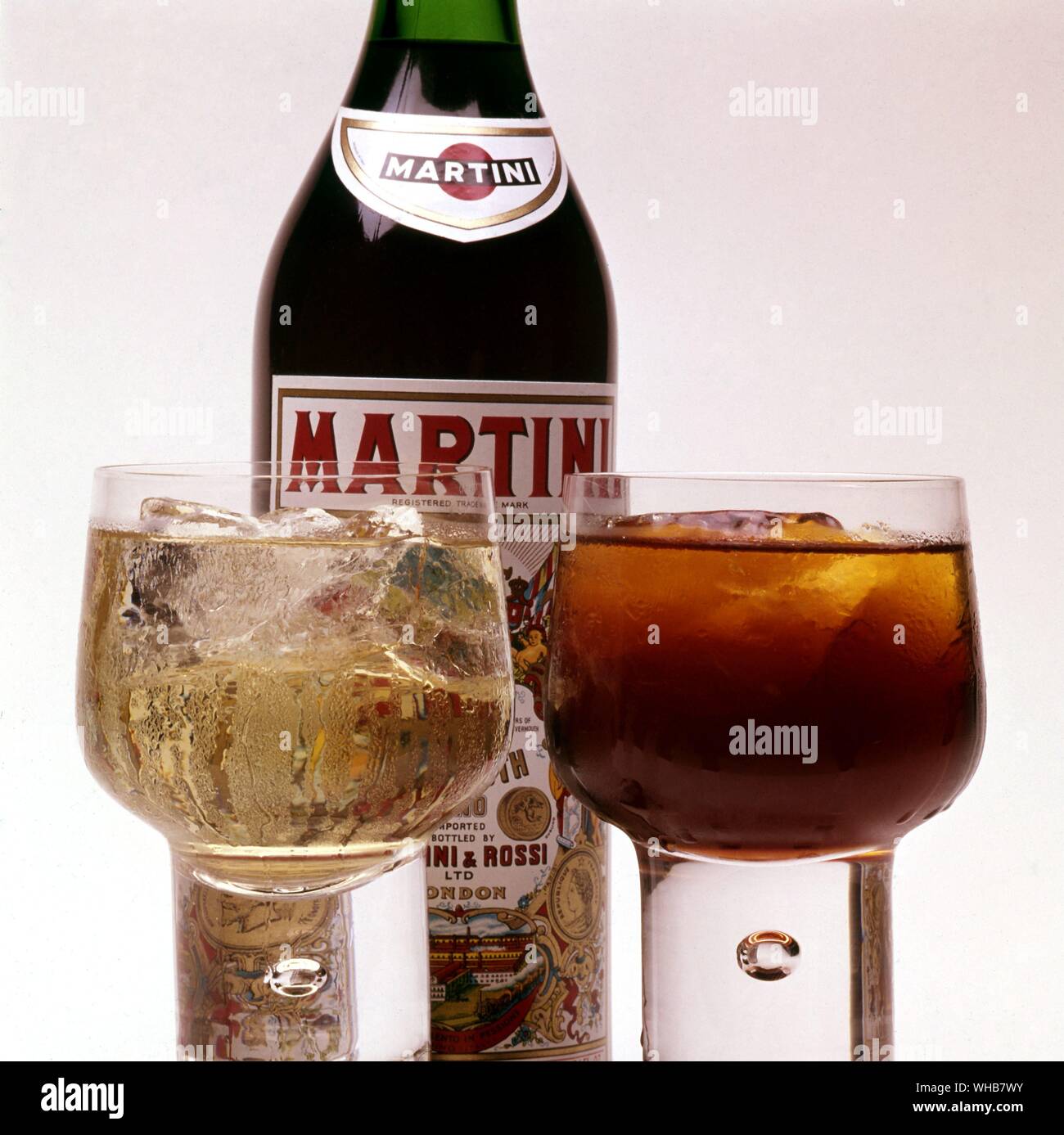 Red Martini bottle with full glasses in front. Stock Photo