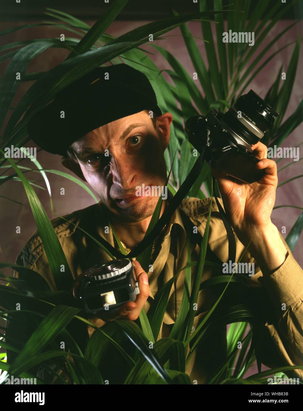 Photographer with camera and light meter Stock Photo