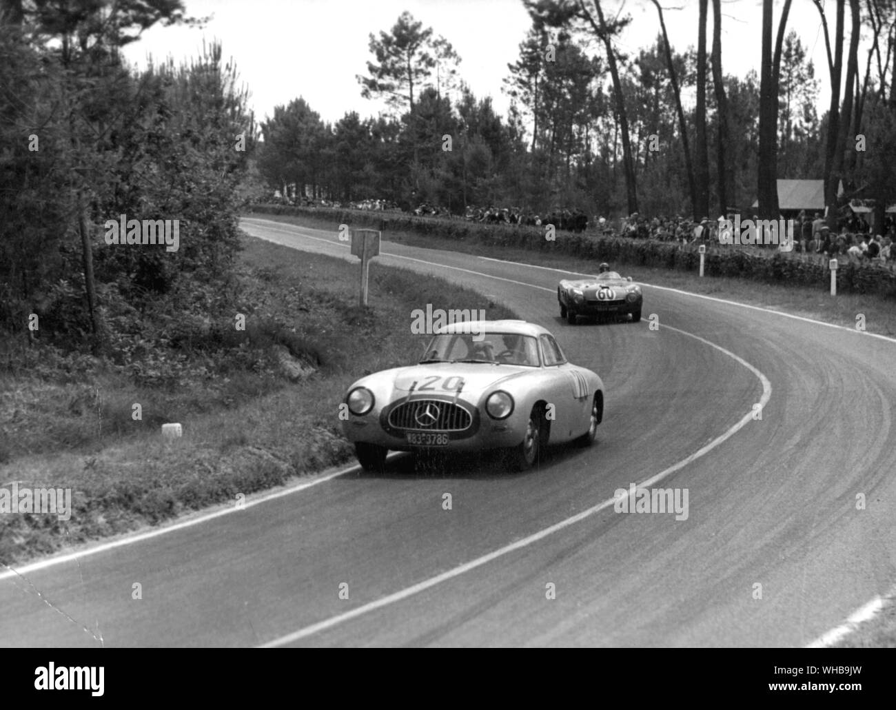 German team Mercedes-Benz 300 SL car competitor during the 24 hour Le Mans endurance motor race ahead on corner from French Monopole X84 Panhard car. 14 June 1952 Stock Photo
