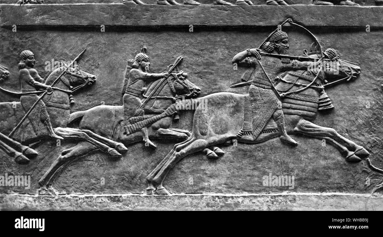 King Ashurbanipal in a  relief on horseback drawing bow Stock Photo