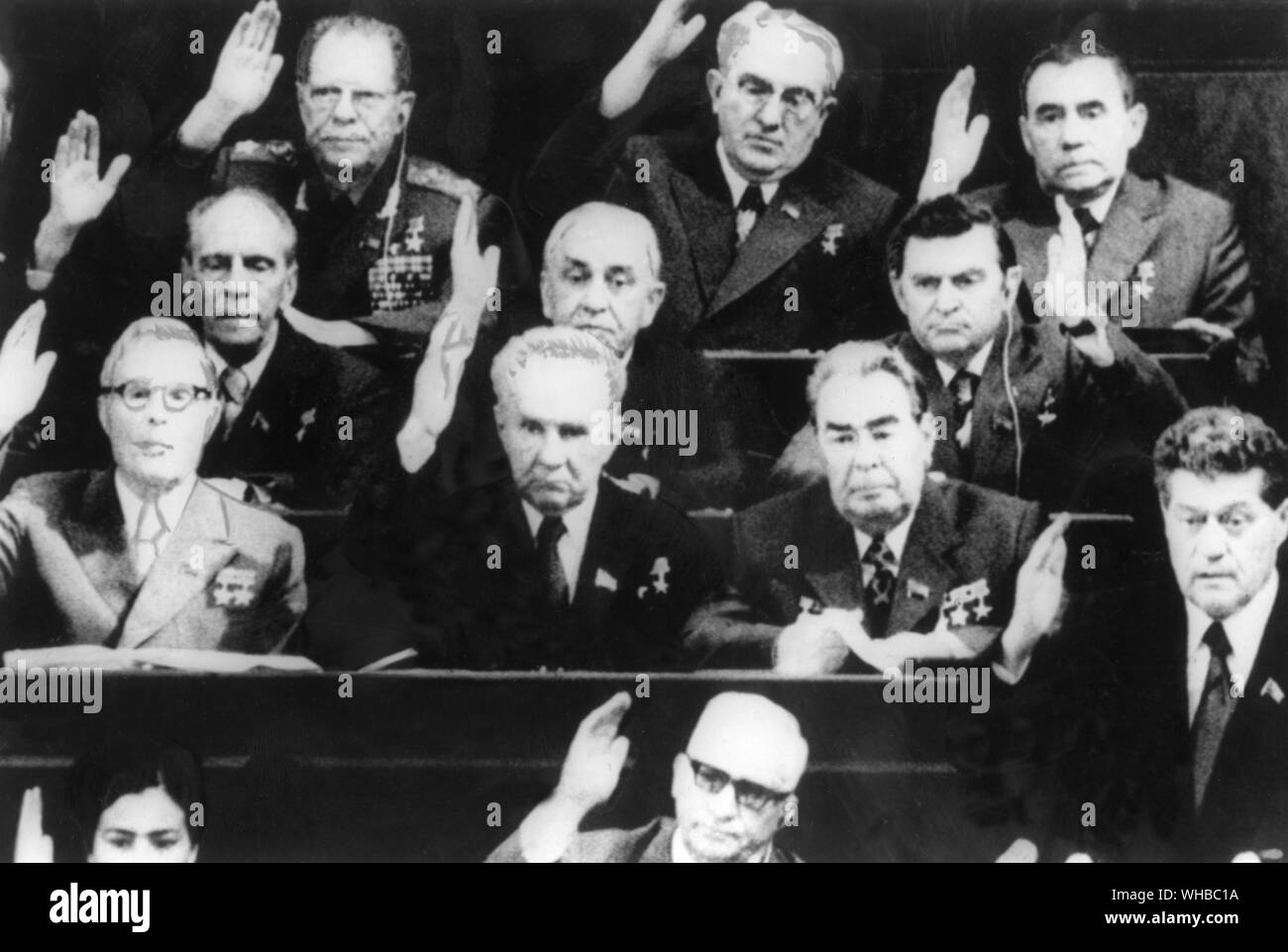 Mr. Brezhnev (second row from bottom, first on the right, only person with no hand up) sitting in Parliament in Moscow 16 June 1977 as members of the Communist Party Politburo voted for him to succeed Mr. Podgorny as president.. Leonid Ilyich Brezhnev (December 19, 1906 [O.S. December 6, 1906] - November 10, 1982) was General Secretary of the Communist Party of the Soviet Union (and thus political leader of the USSR) from 1964 to 1982, serving in that position longer than anyone other than Joseph Stalin. He was twice Chairman of the Presidium of the Supreme Soviet (head of state), from 1960 Stock Photo