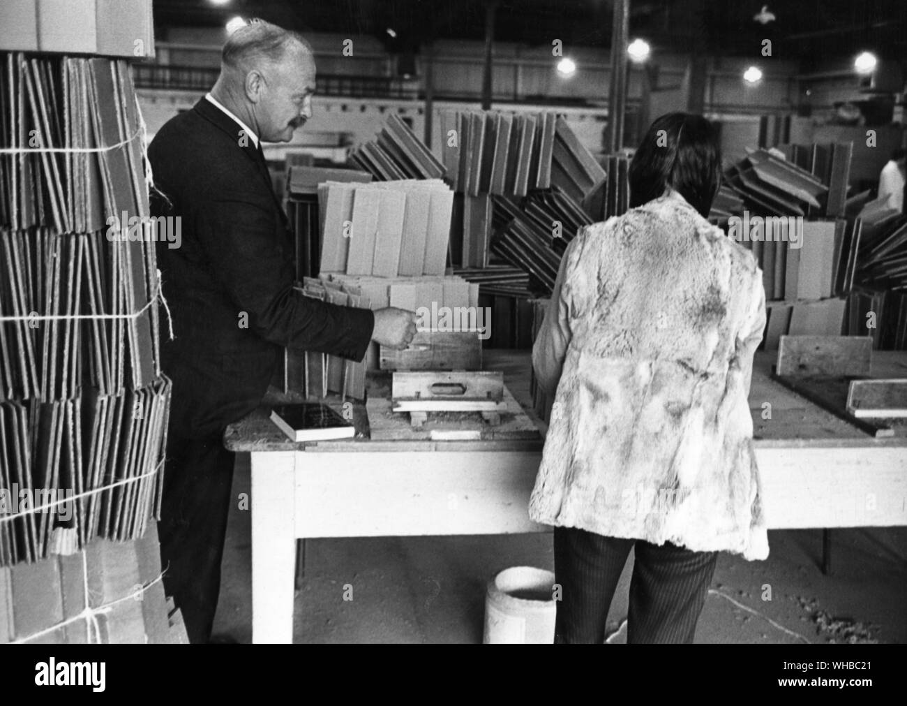 Drug centre at St. John's Hospital , Lincoln - picture showa a doctor looking on as a 17 year old drug addict makes cardboard boxes in the rehabitation section of the hospital.. Stock Photo