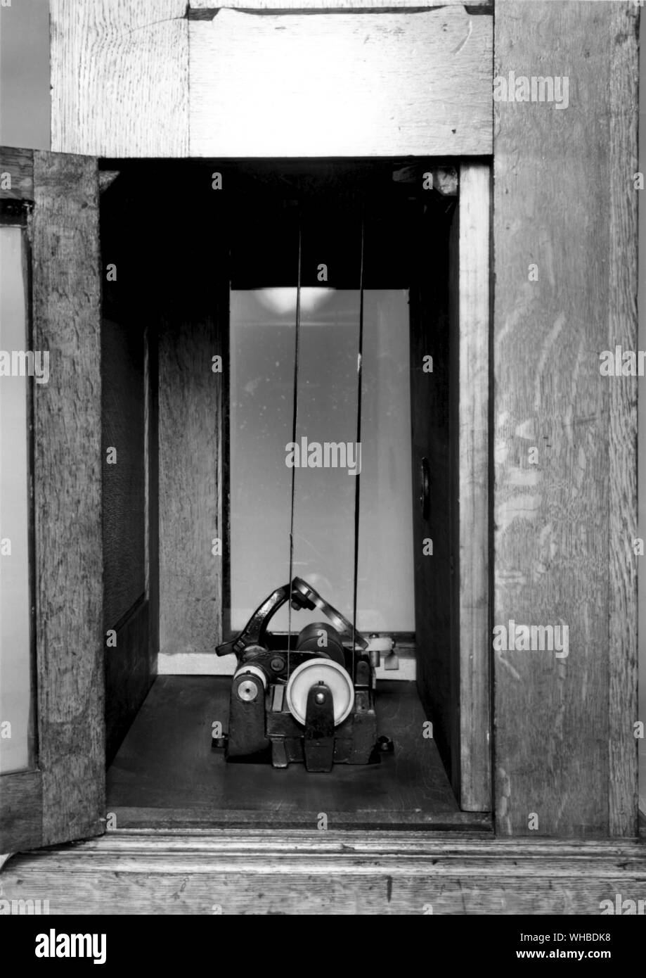 The Kinetoscope is an early motion picture exhibition device. Though not a movie projector it was designed for films to be viewed individually through the window of a cabinet housing its components—the Kinetoscope introduced the basic approach that would become the standard for all cinematic projection before the advent of video: it creates the illusion of movement by conveying a strip of perforated film bearing sequential images over a light source with a high-speed shutter.. Stock Photo