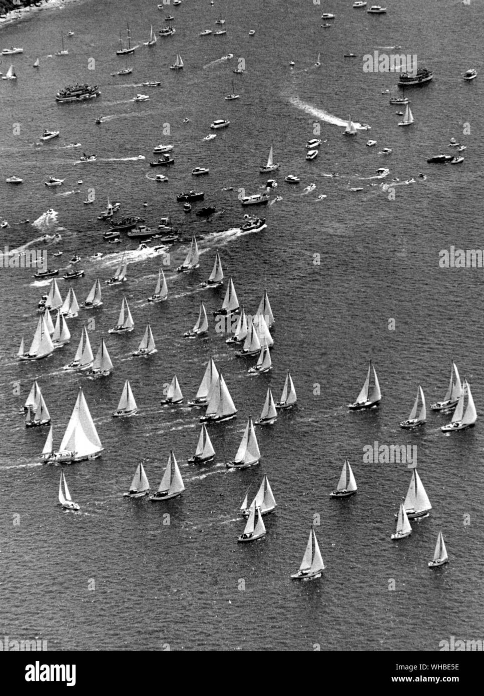 Yachts proceeding down Sydney Harbour after the start of the Sydney-Hobart race.. Stock Photo
