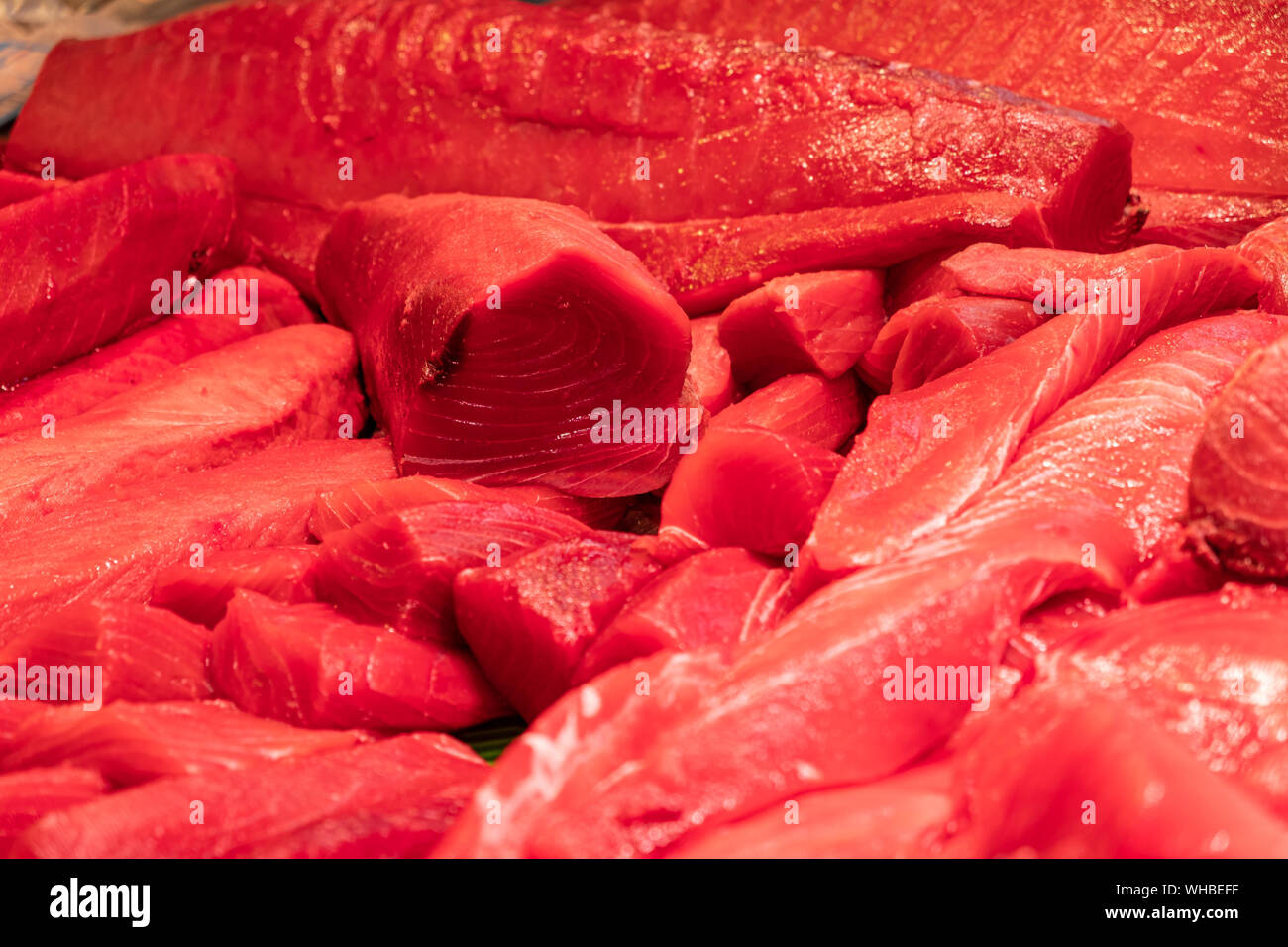 Freshly cut and exposed red tuna loins at the fish shop counter Stock Photo