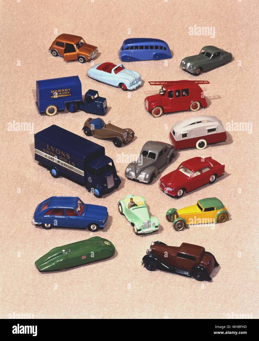Dinky toys : die-cast miniature model cars and trucks . Mini Clubman 1976 . streamlined coach 1938 . Jaguar XK 120 1954 . Austin A40 Atlantic 1951 . streamlined fire engine with ten firemen 1938 . Hornby box van 1940 . Jaguar SS 100 1946 . Studebaker State Commender coupe 1946 . towing a caravan 1938 . Lyons Guy delivery van 1952 . Volvo 122S 1962 . Renault R16 1970 . MG TF 1957 . Sports coupe 1933 . MG record car 1940 . Humber Vogue 1946 . Stock Photo