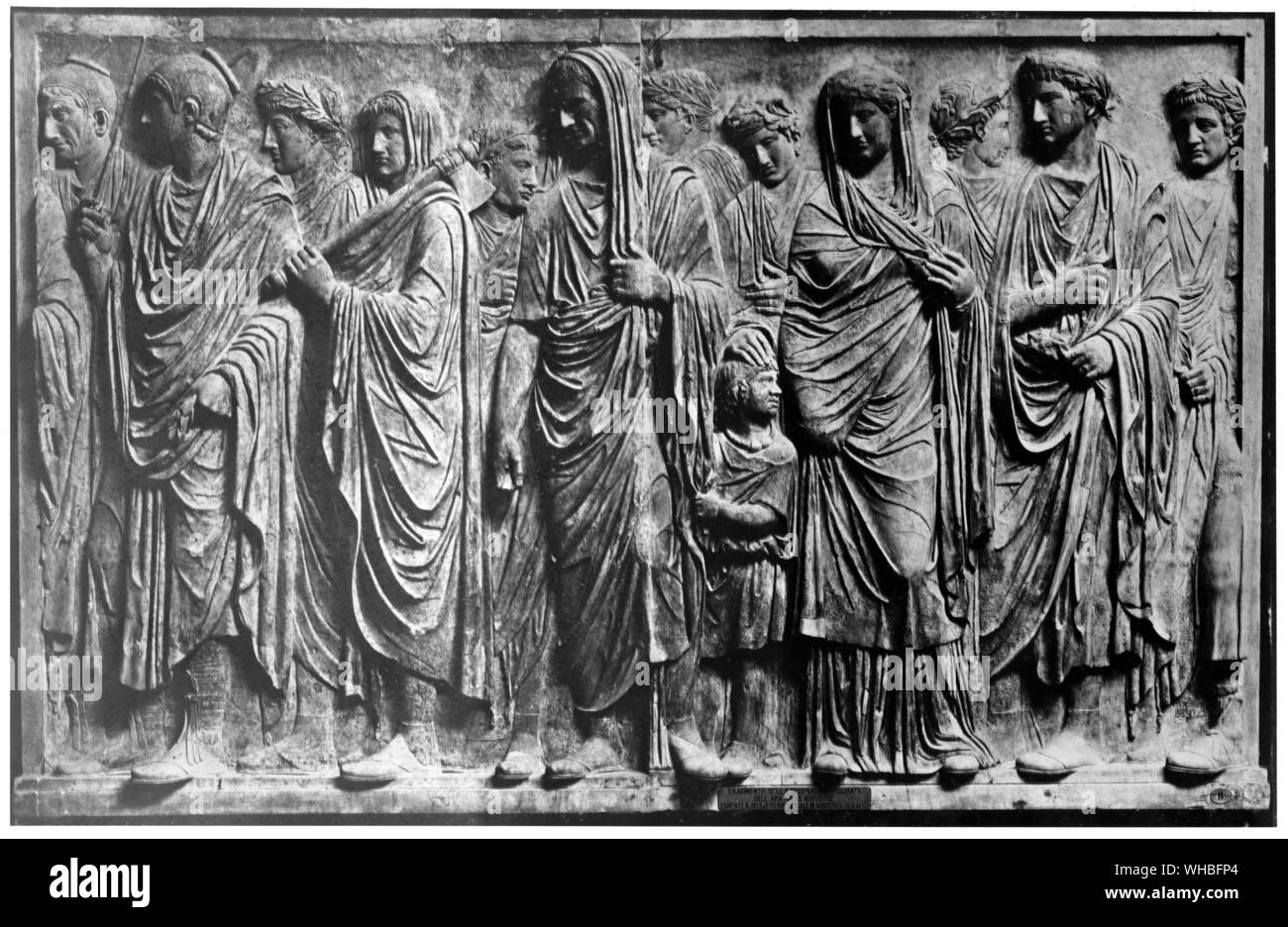 Processional frieze from the altar of the Augustin Peace 13-9 BC - Rome. The Ara Pacis Augustae (Latin, Altar of Majestic Peace. commonly shortened to Ara Pacis) is an altar to Peace, envisioned as a Roman goddess. It was commissioned by the Roman Senate on 4 July 13 BC to honor the triumphal return from Hispania and Gaul of the Roman emperor Augustus, and was consecrated on 30 January 9 BC by the Senate to celebrate the peace established in the Empire after Augustus's victories The altar was meant to be a vision of the Roman civil religion. It sought to portray the peace and fertile Stock Photo