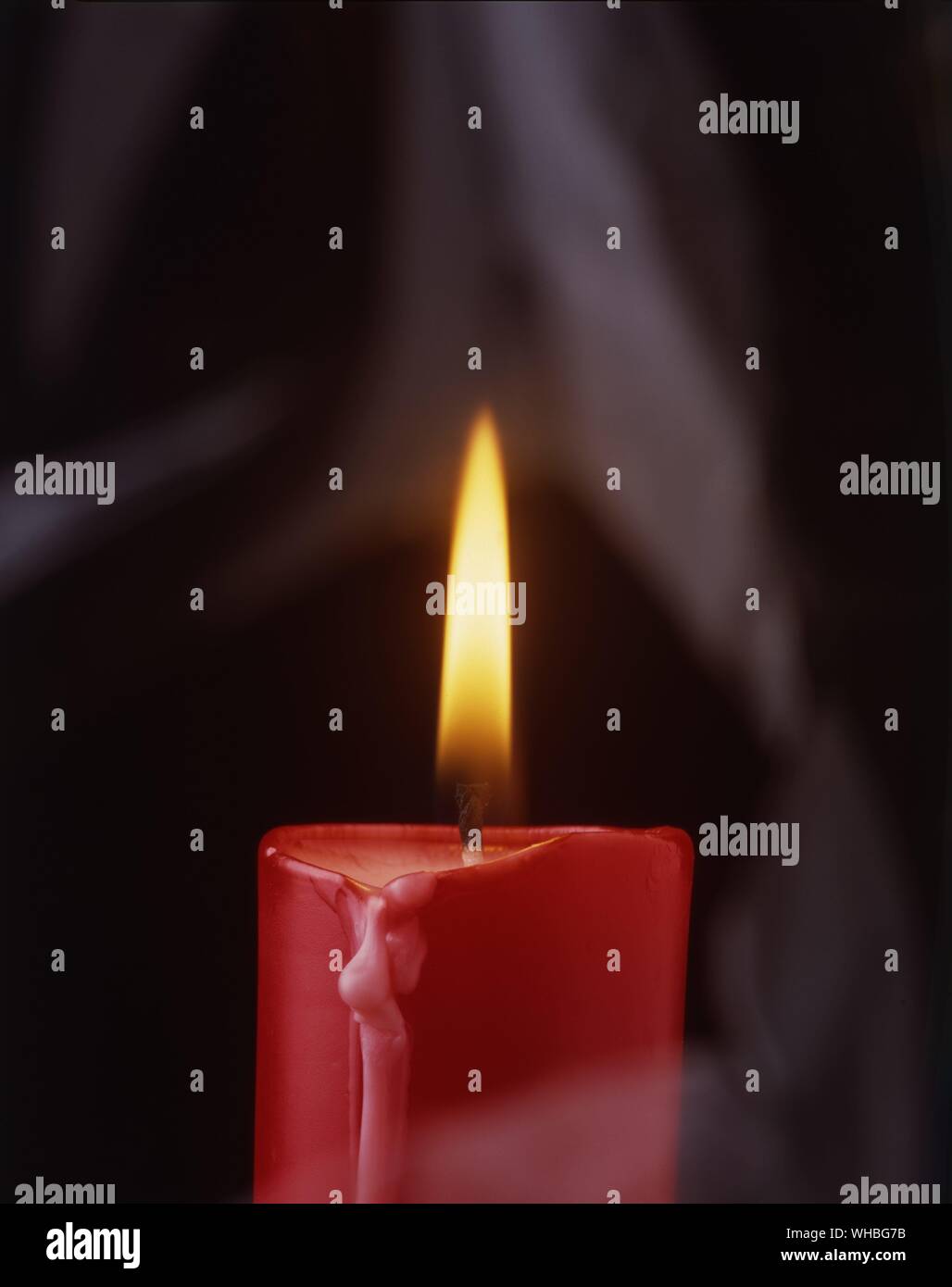 Red candle with flame. Stock Photo